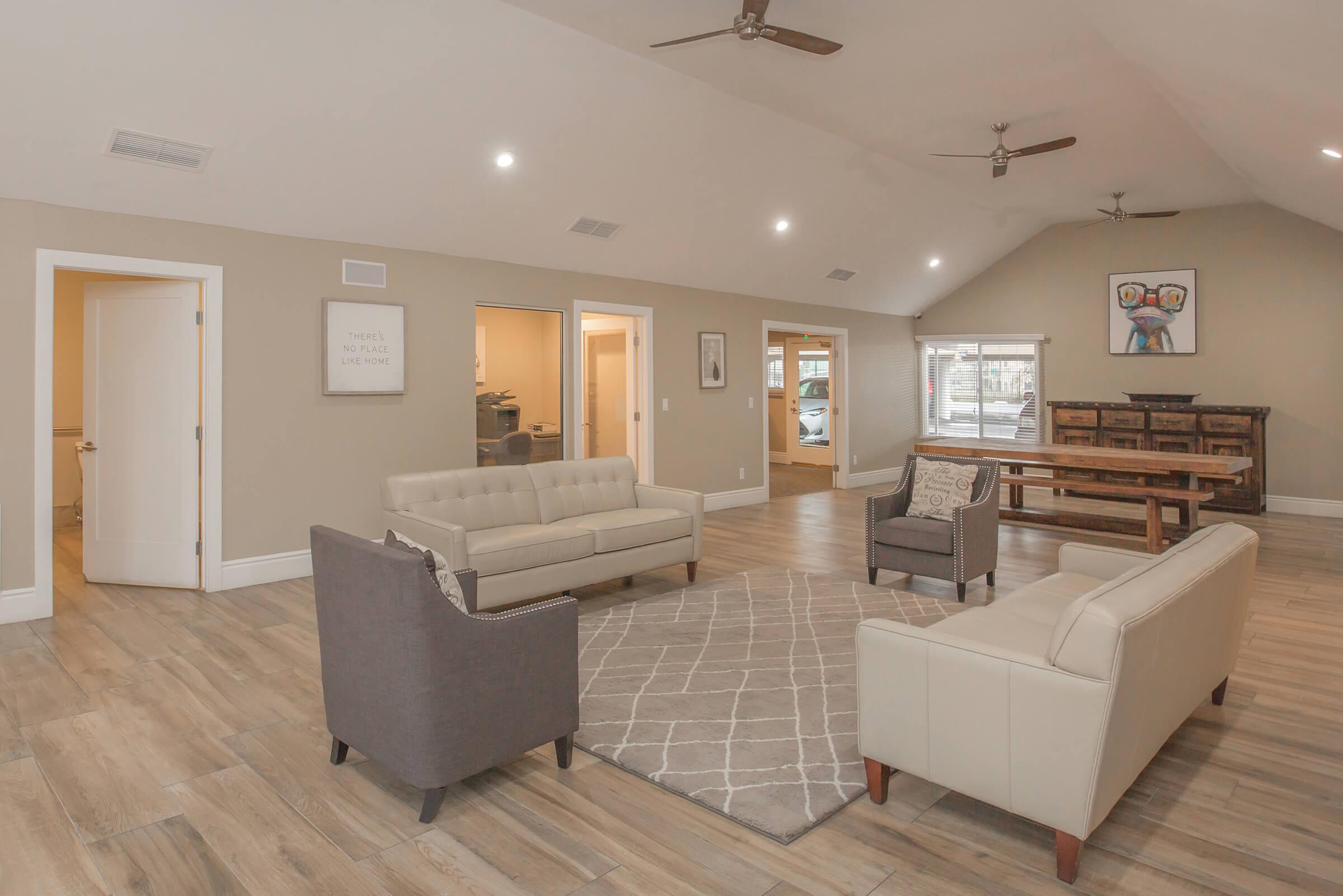 a living room filled with furniture and a flat screen tv