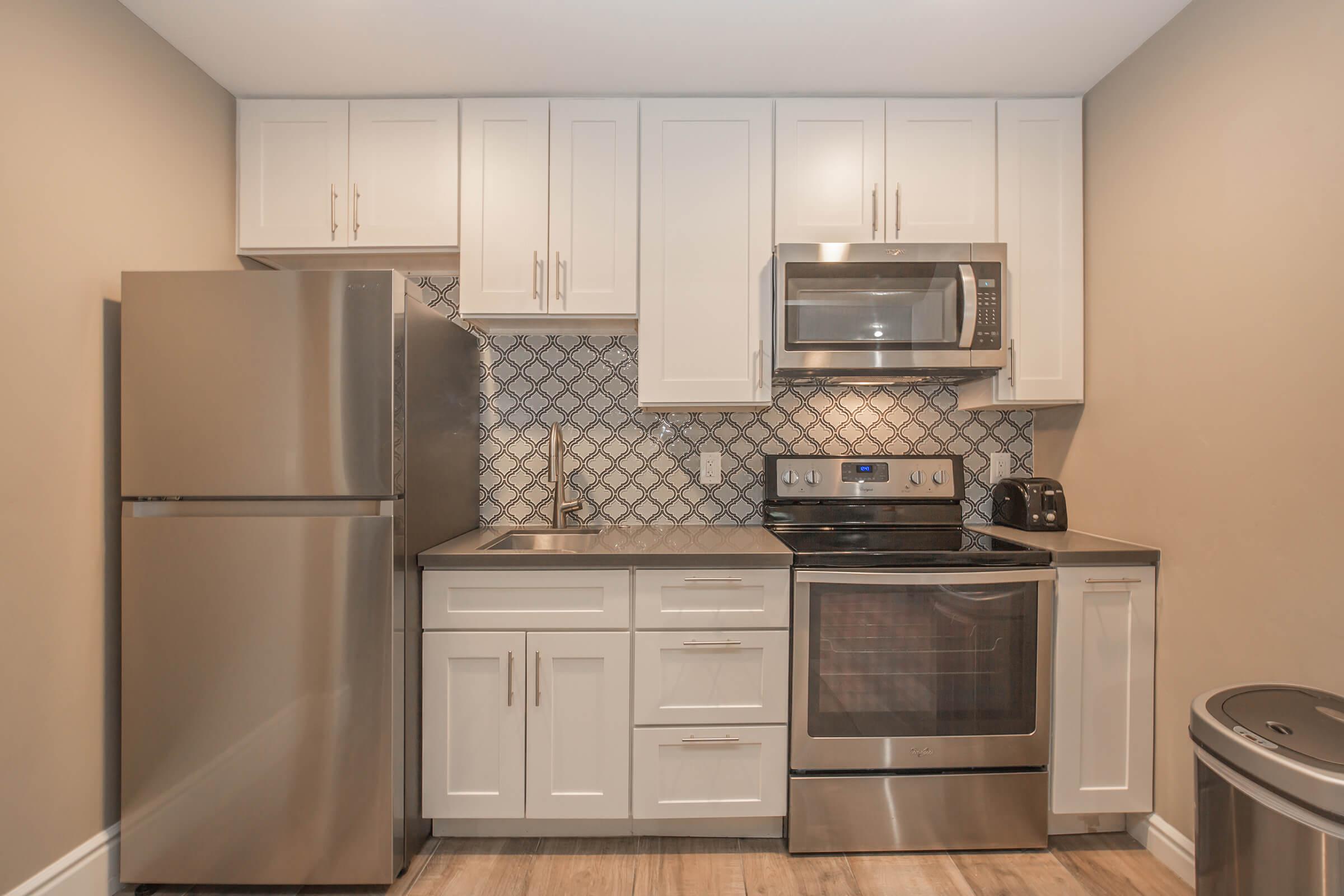 a kitchen with stainless steel appliances and wooden cabinets