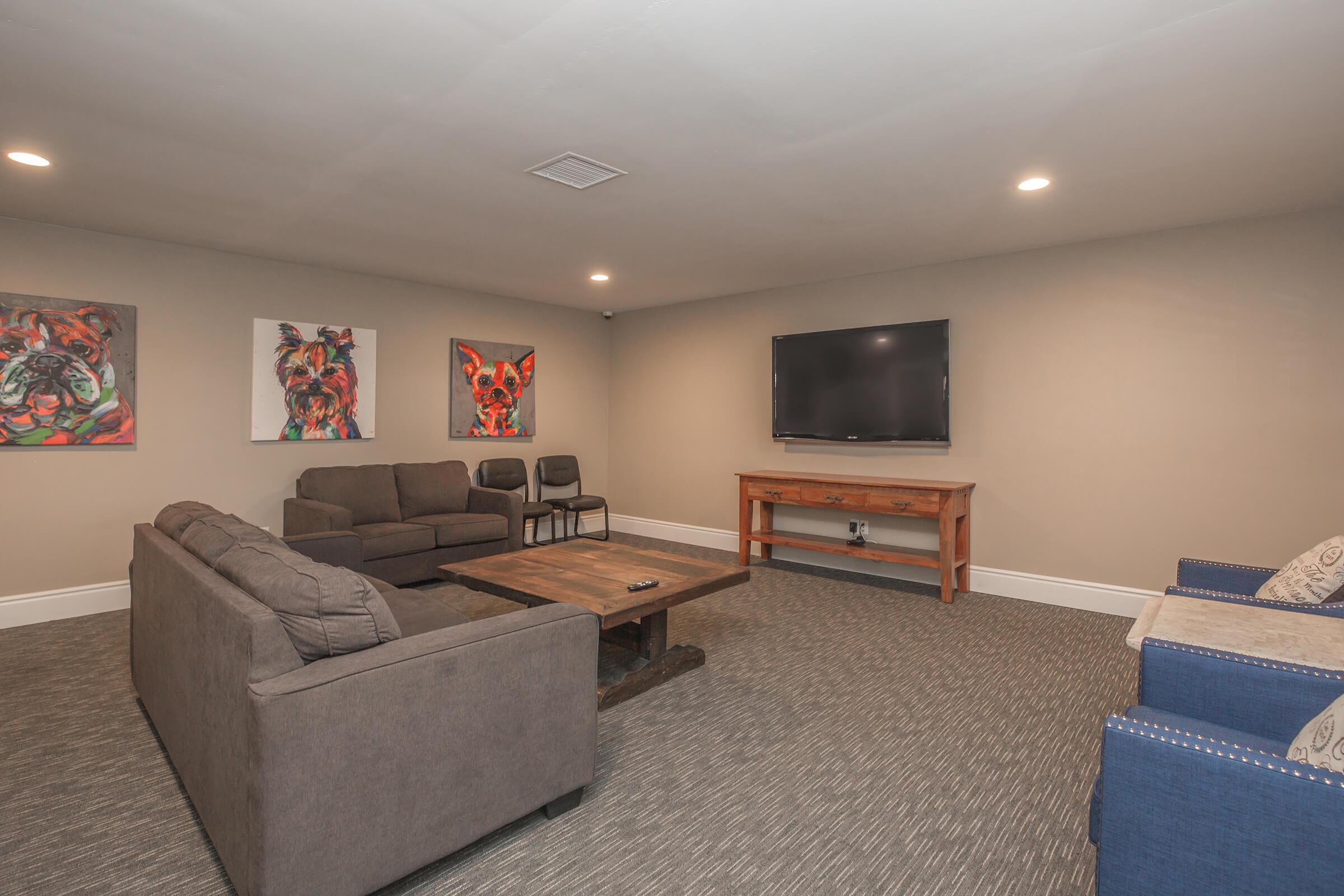 a living room filled with furniture and a flat screen tv