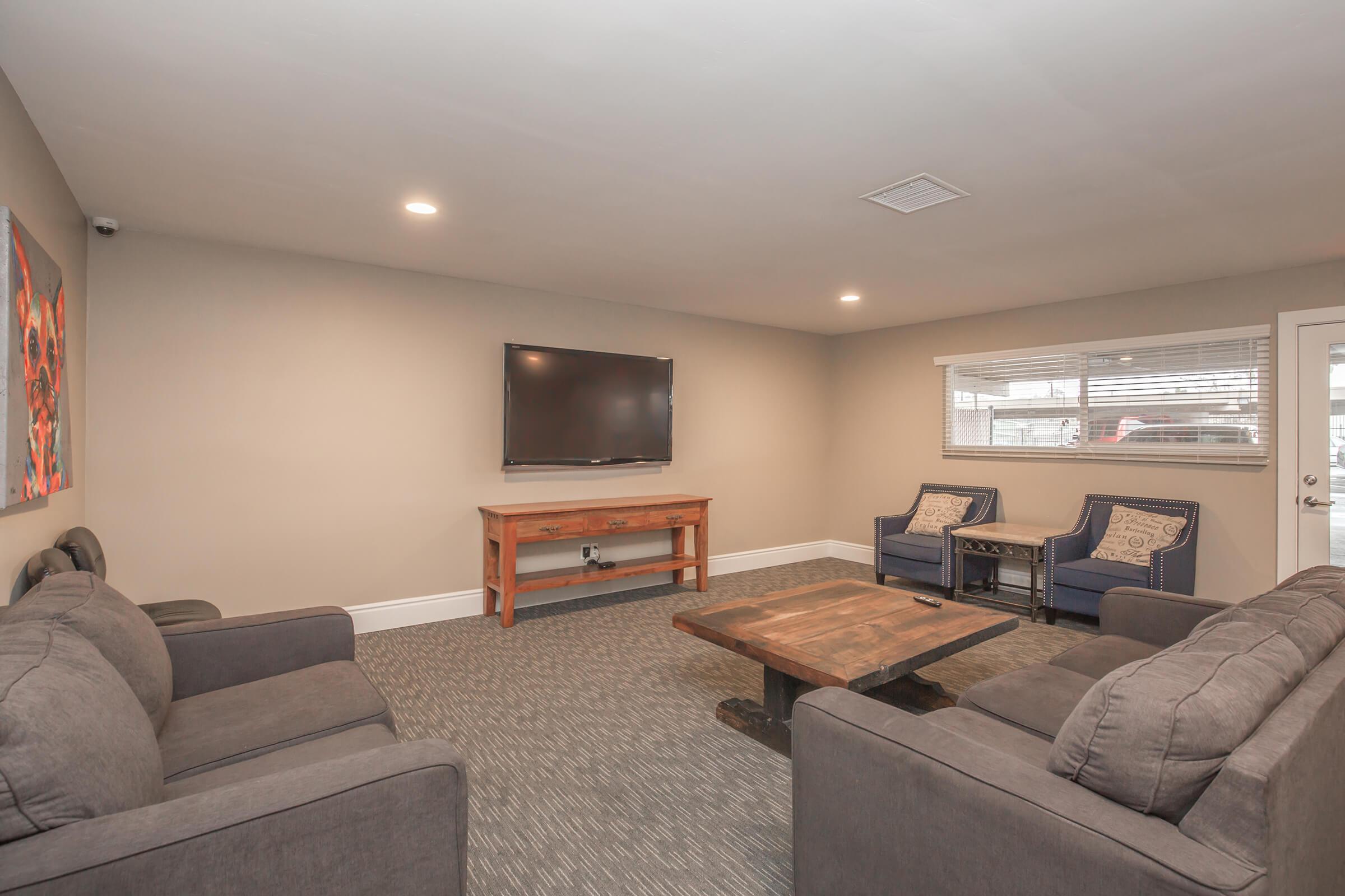 a living room filled with furniture and a flat screen tv