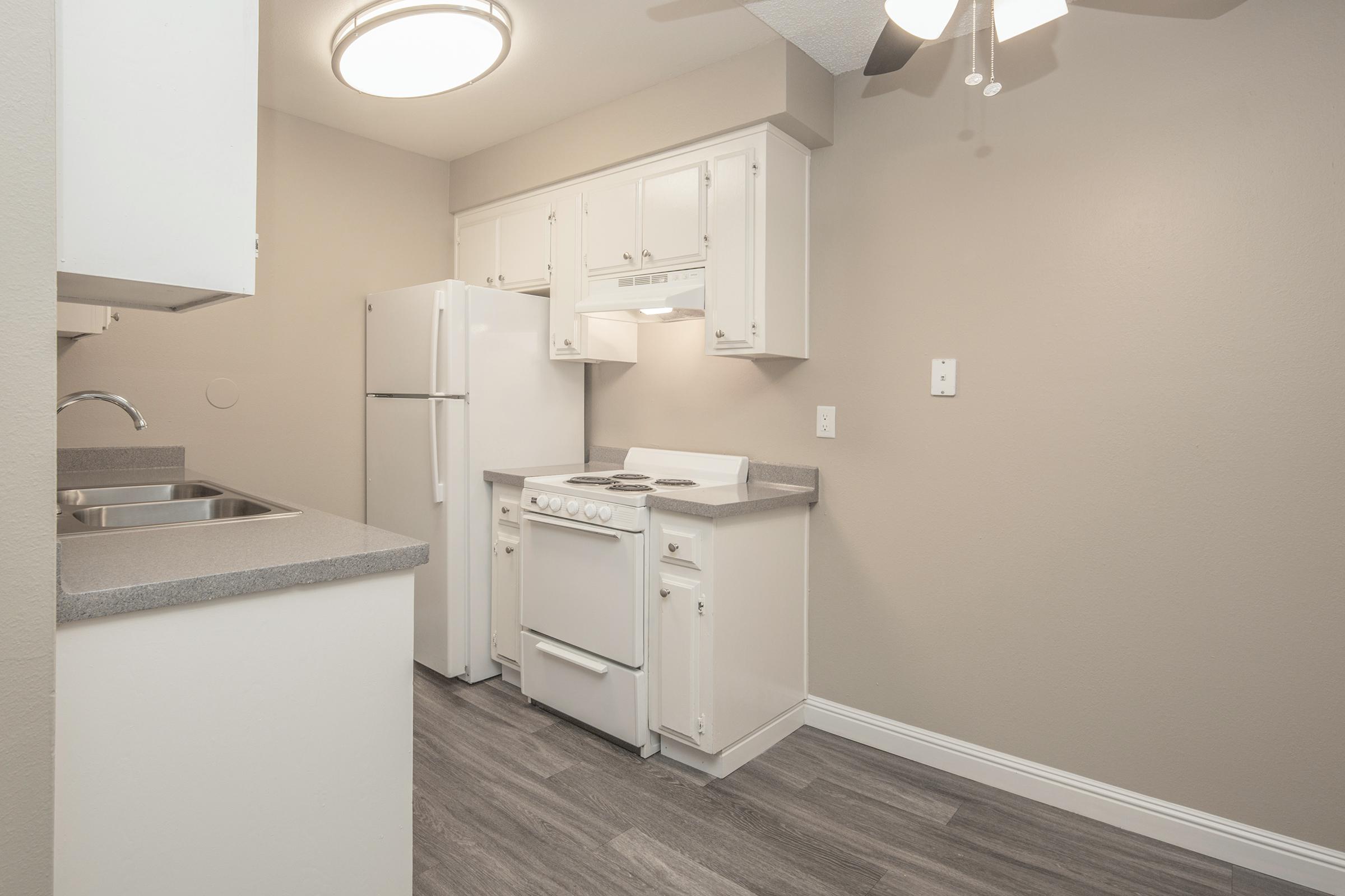 a kitchen with a sink and a mirror