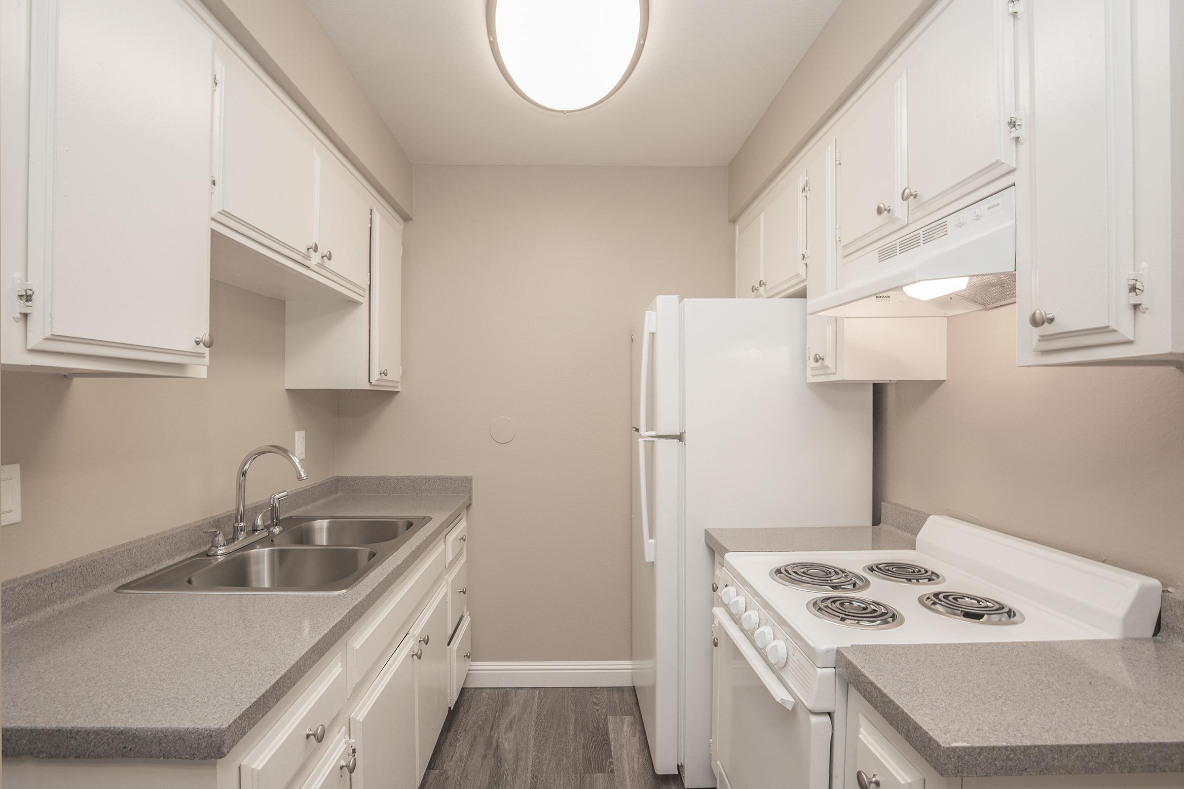 a kitchen with a sink and a refrigerator