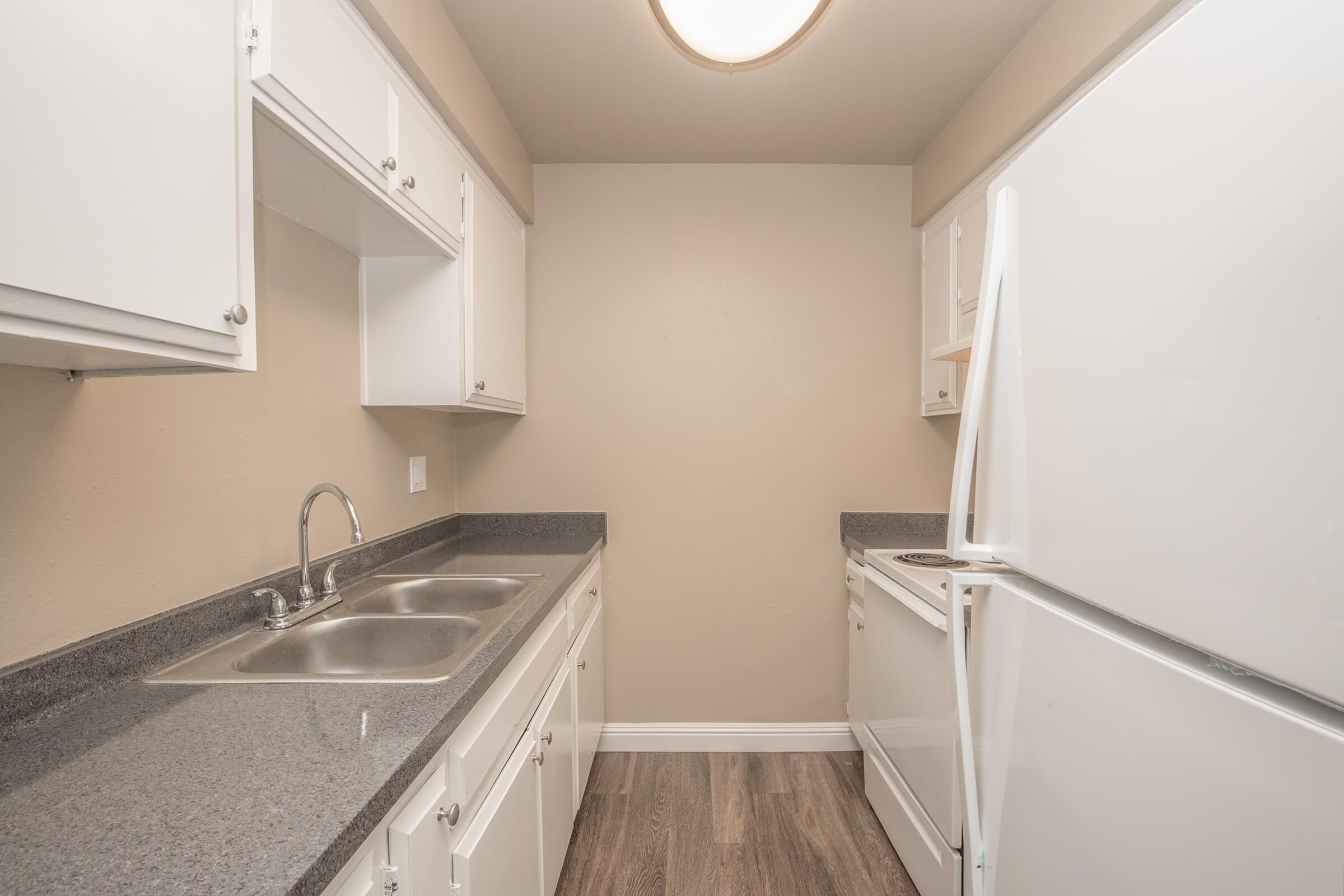 a kitchen with a sink and a mirror