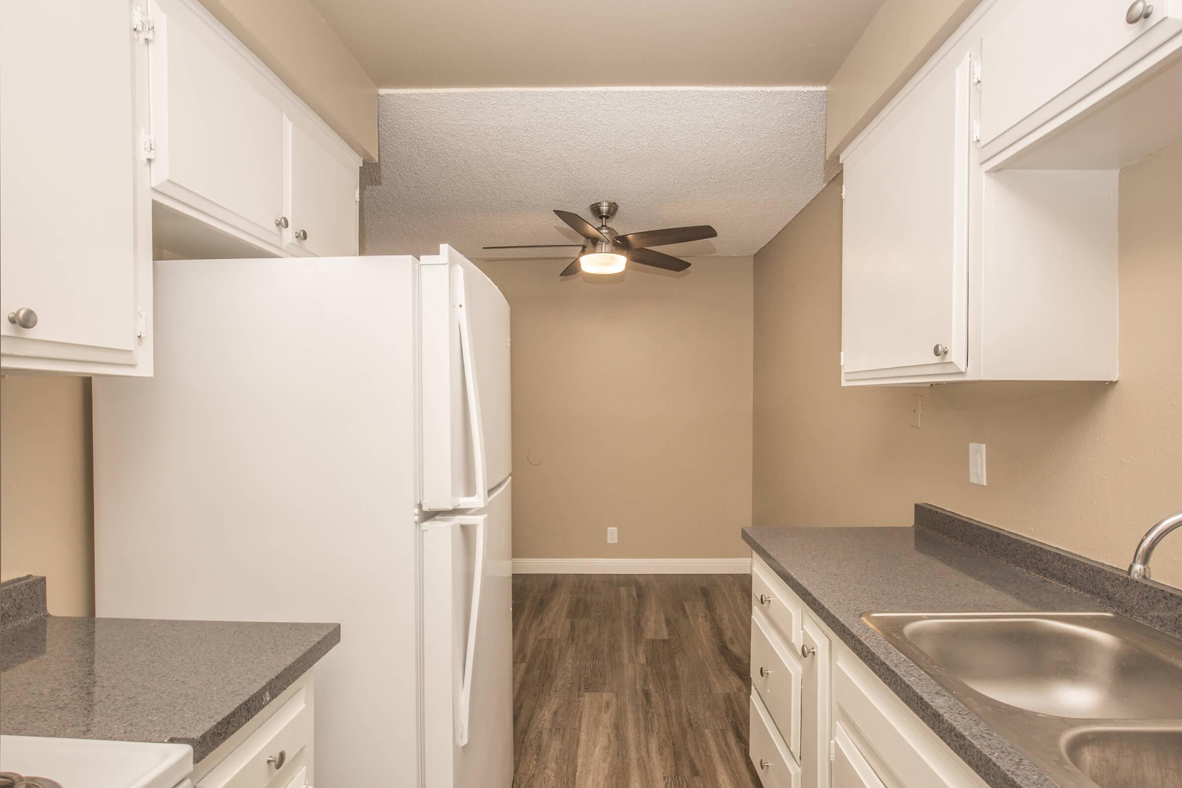 a kitchen with a sink and a mirror