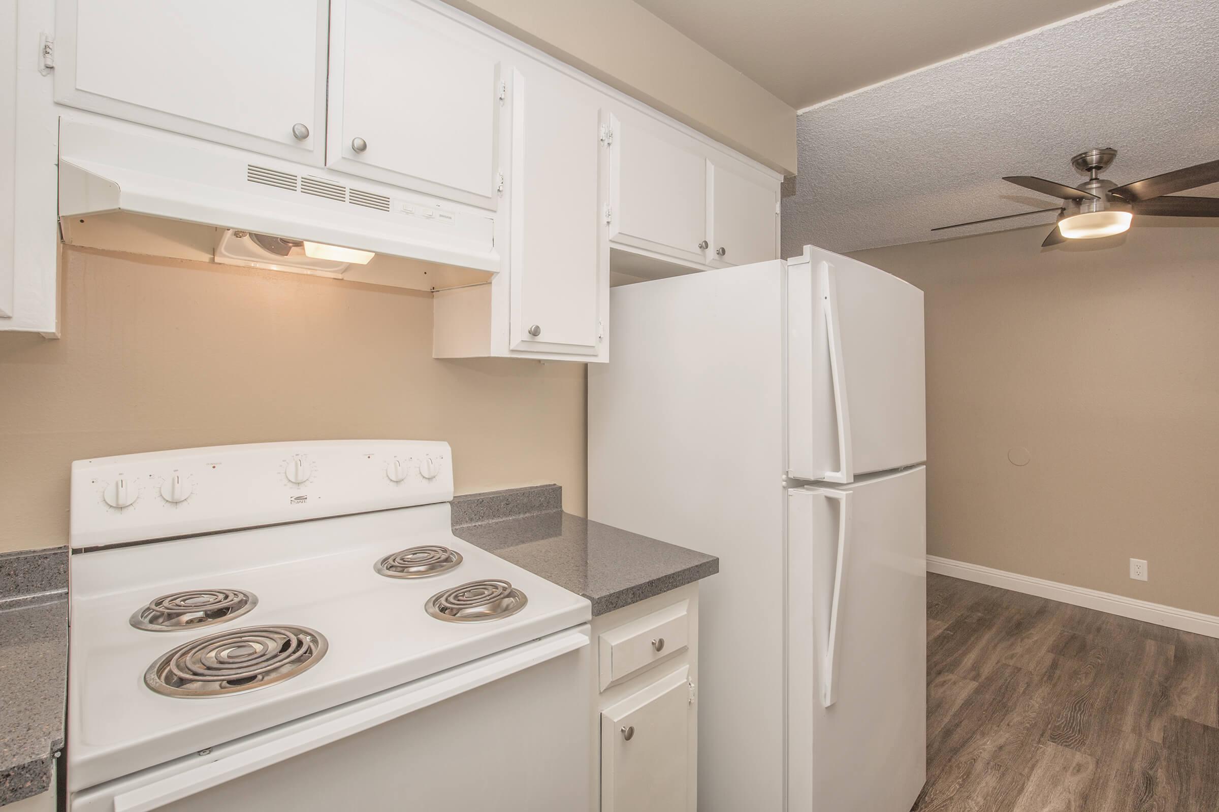 a white refrigerator freezer sitting inside of a kitchen