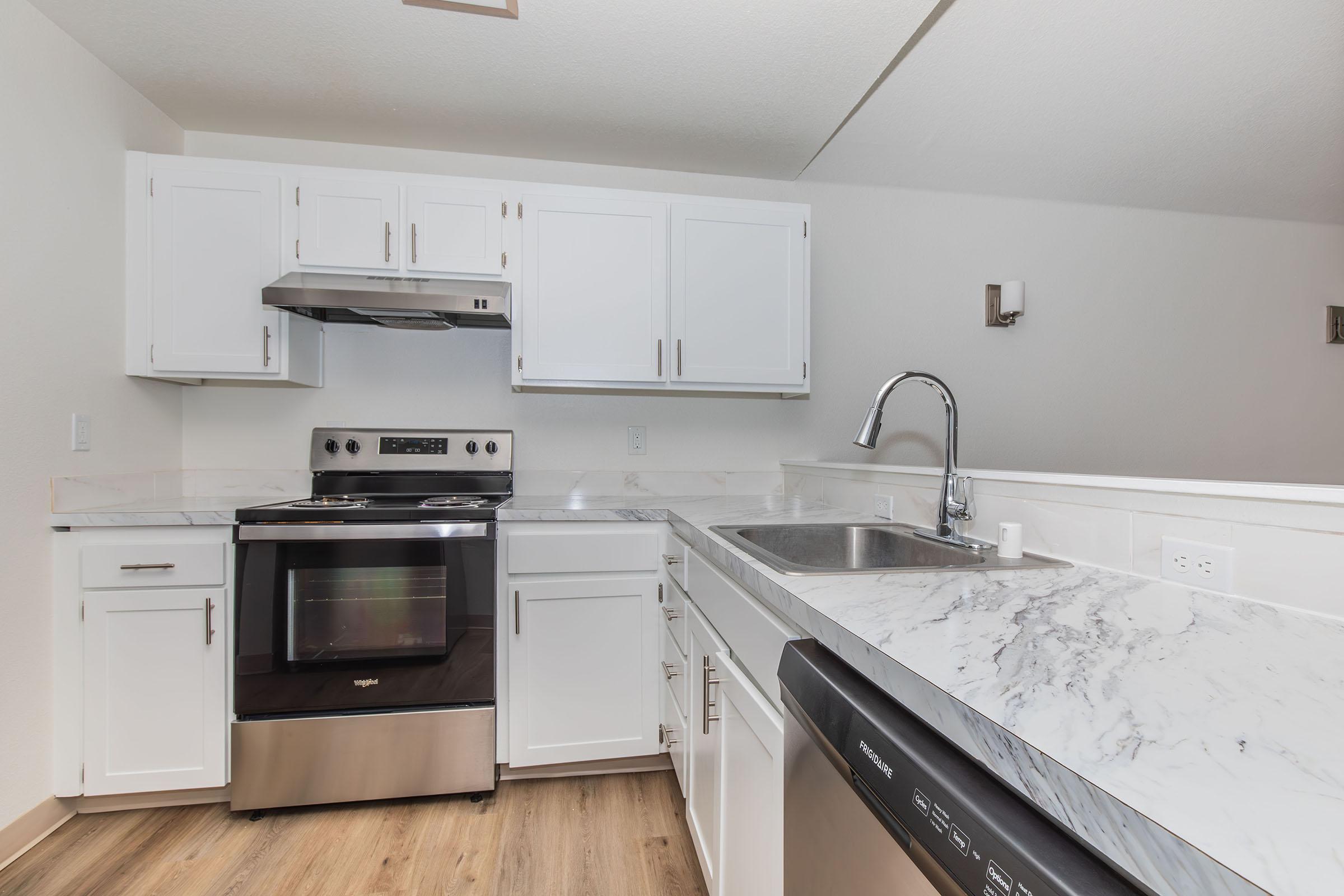 a stove top oven sitting inside of a kitchen