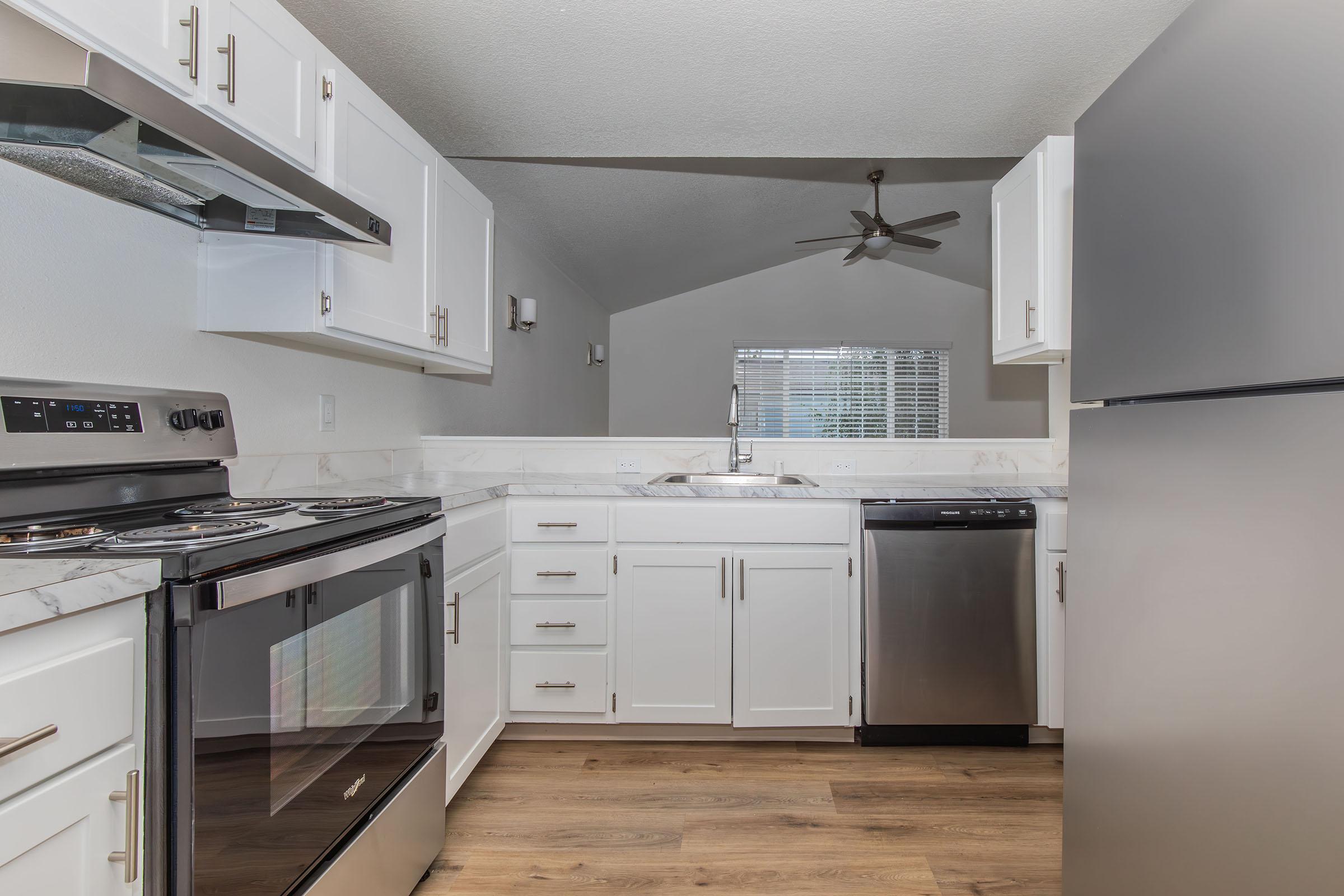 a kitchen with a stove top oven sitting inside of a refrigerator