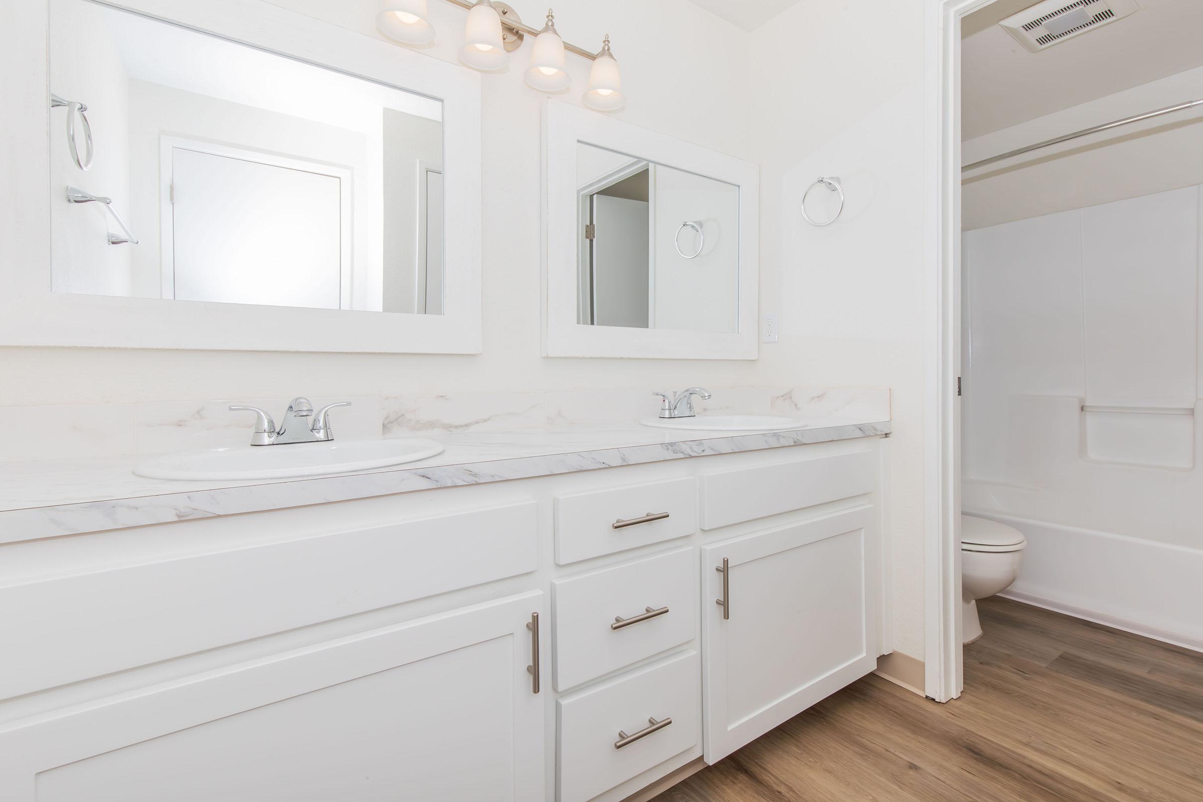 a kitchen with a sink and a mirror