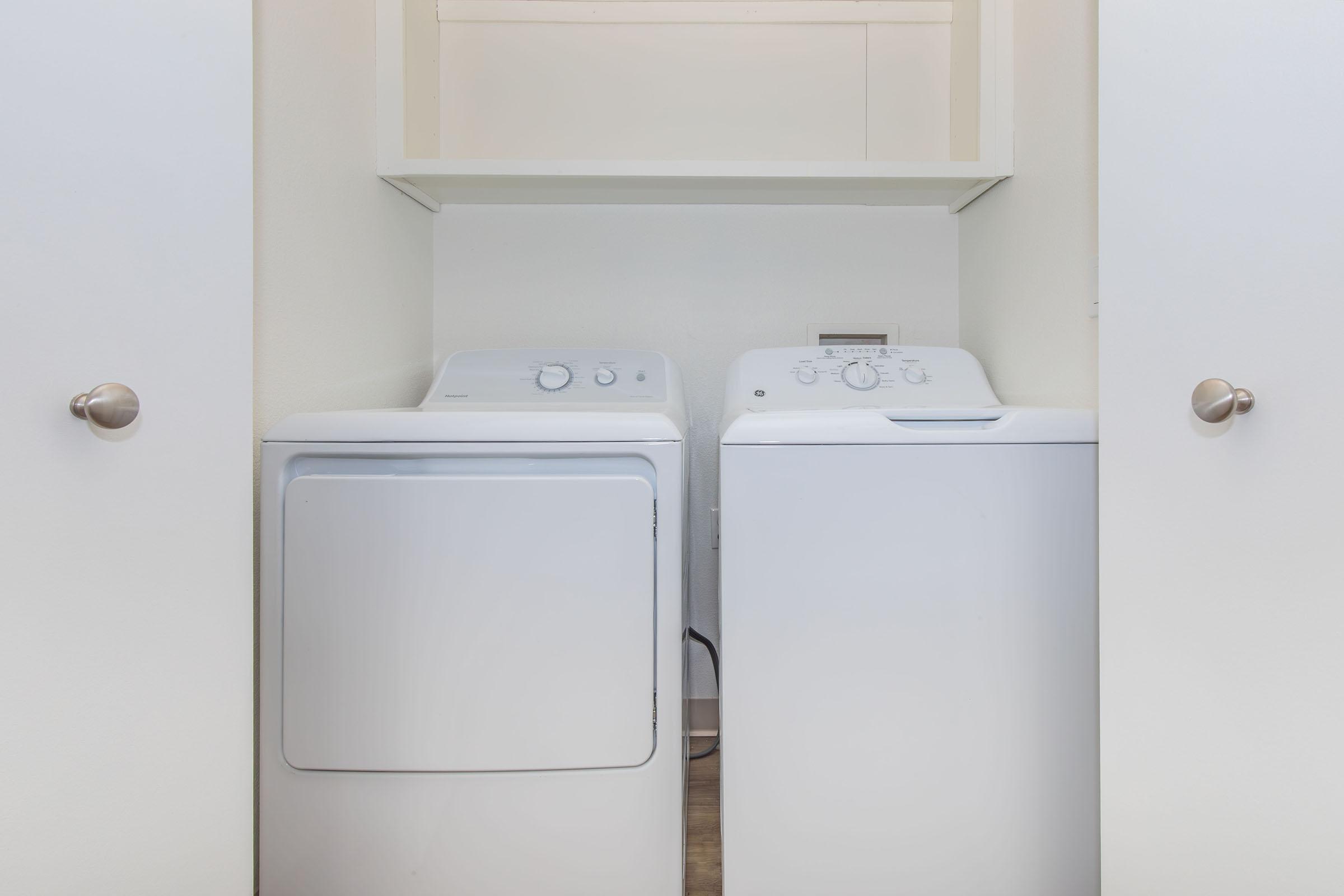 a microwave oven sitting on top of a refrigerator