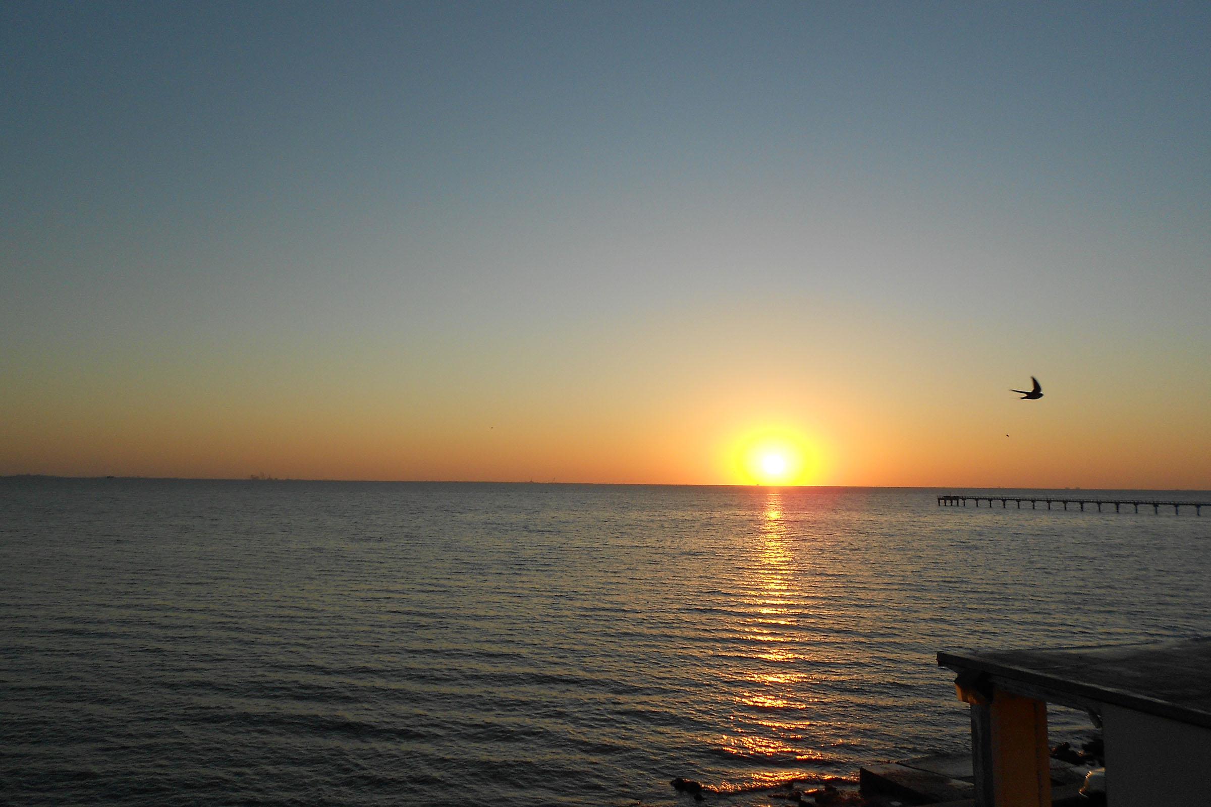 a sunset over a body of water