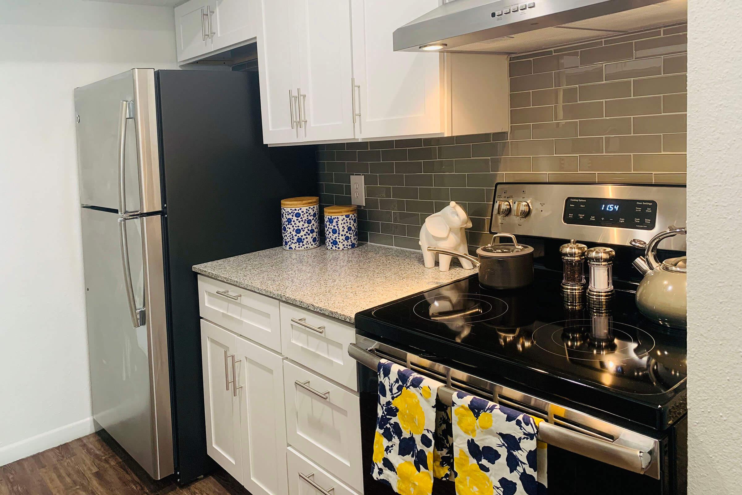 a stove top oven sitting inside of a kitchen