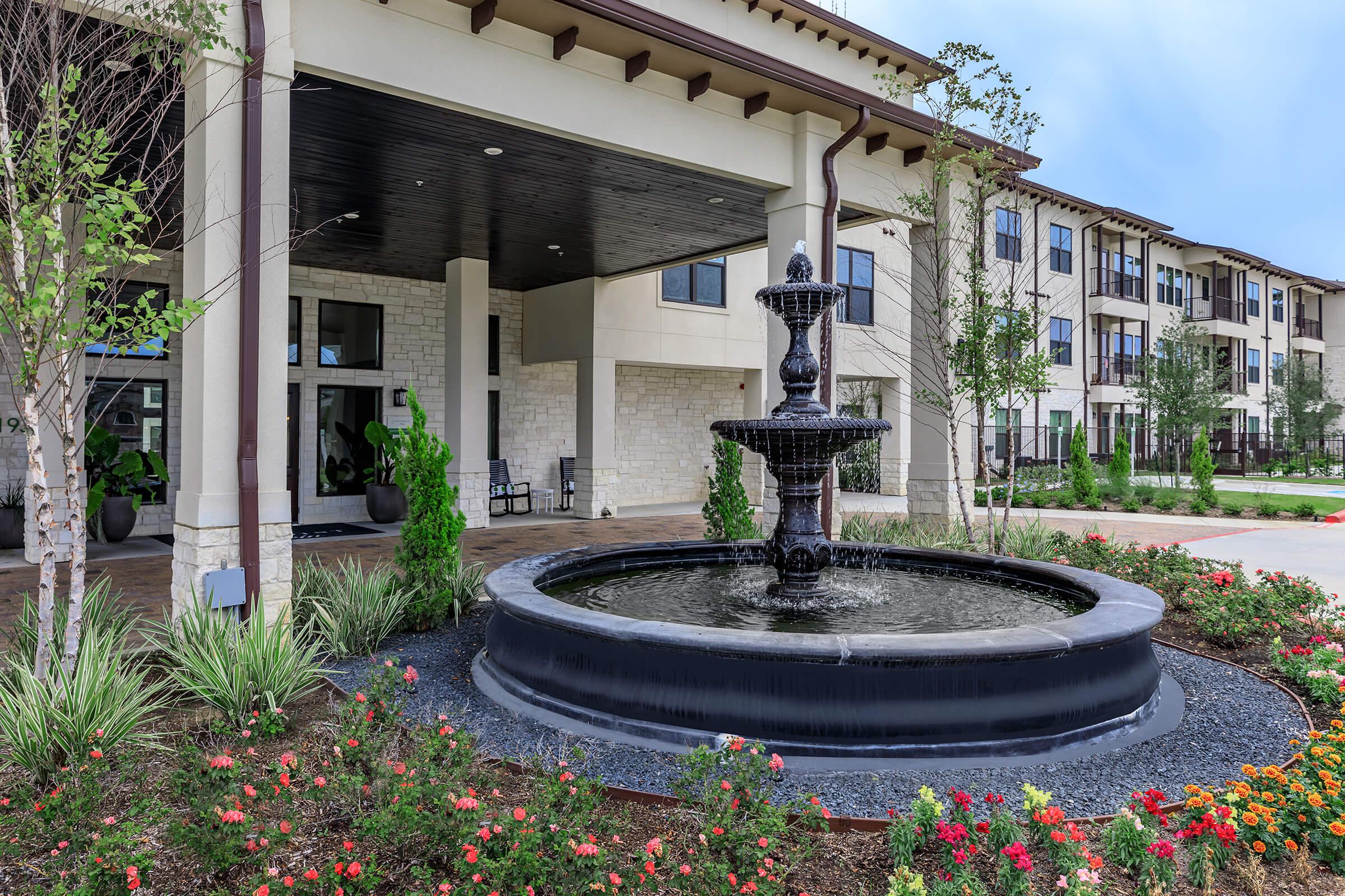 a close up of a flower garden in front of a building