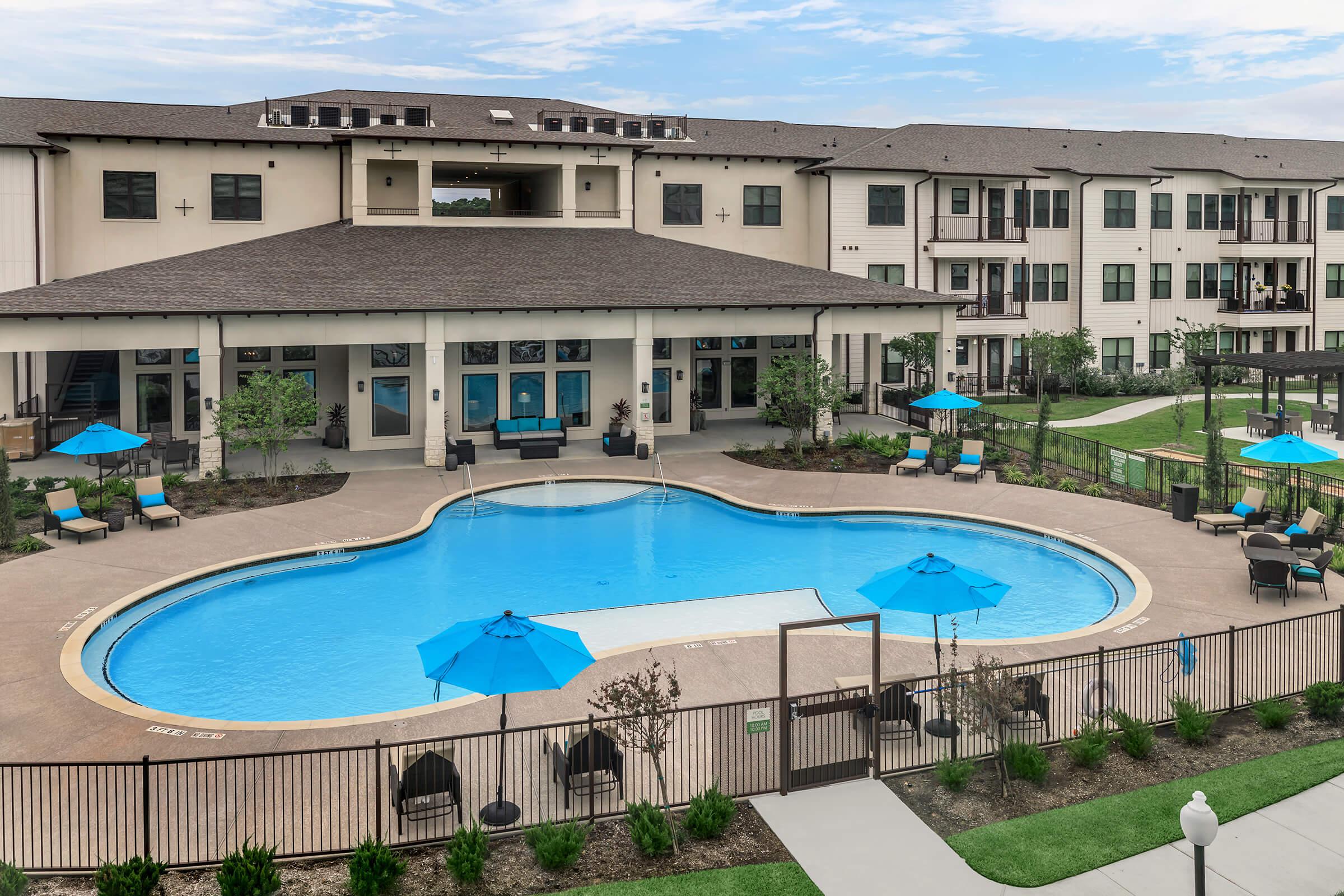 a house with a pool in front of a building