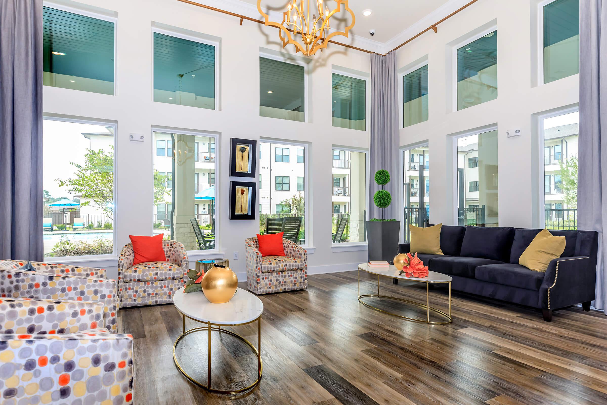 a living room filled with furniture and a large window