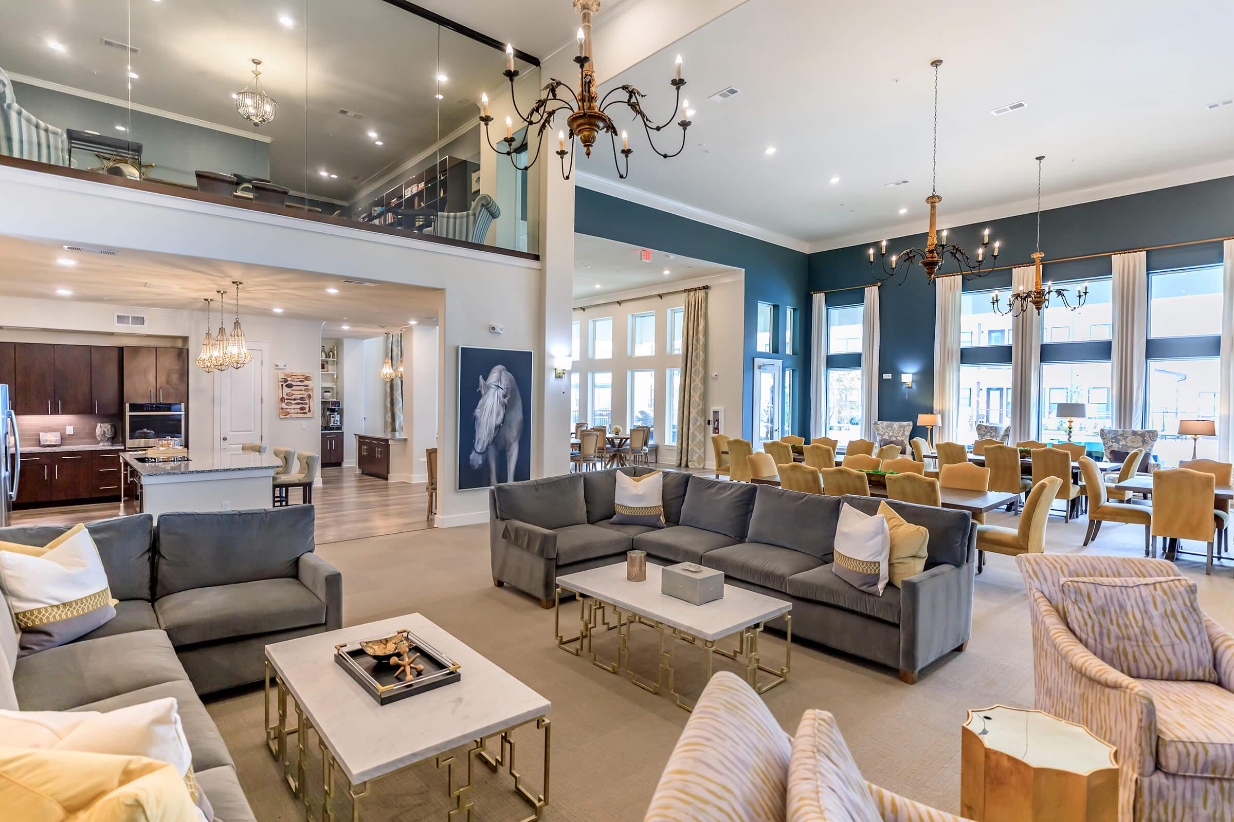 a living room filled with furniture and a large window