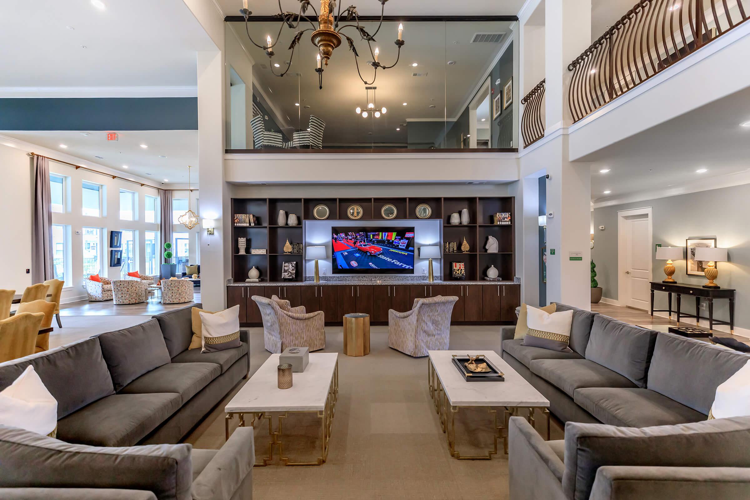 a living room filled with furniture and a large window