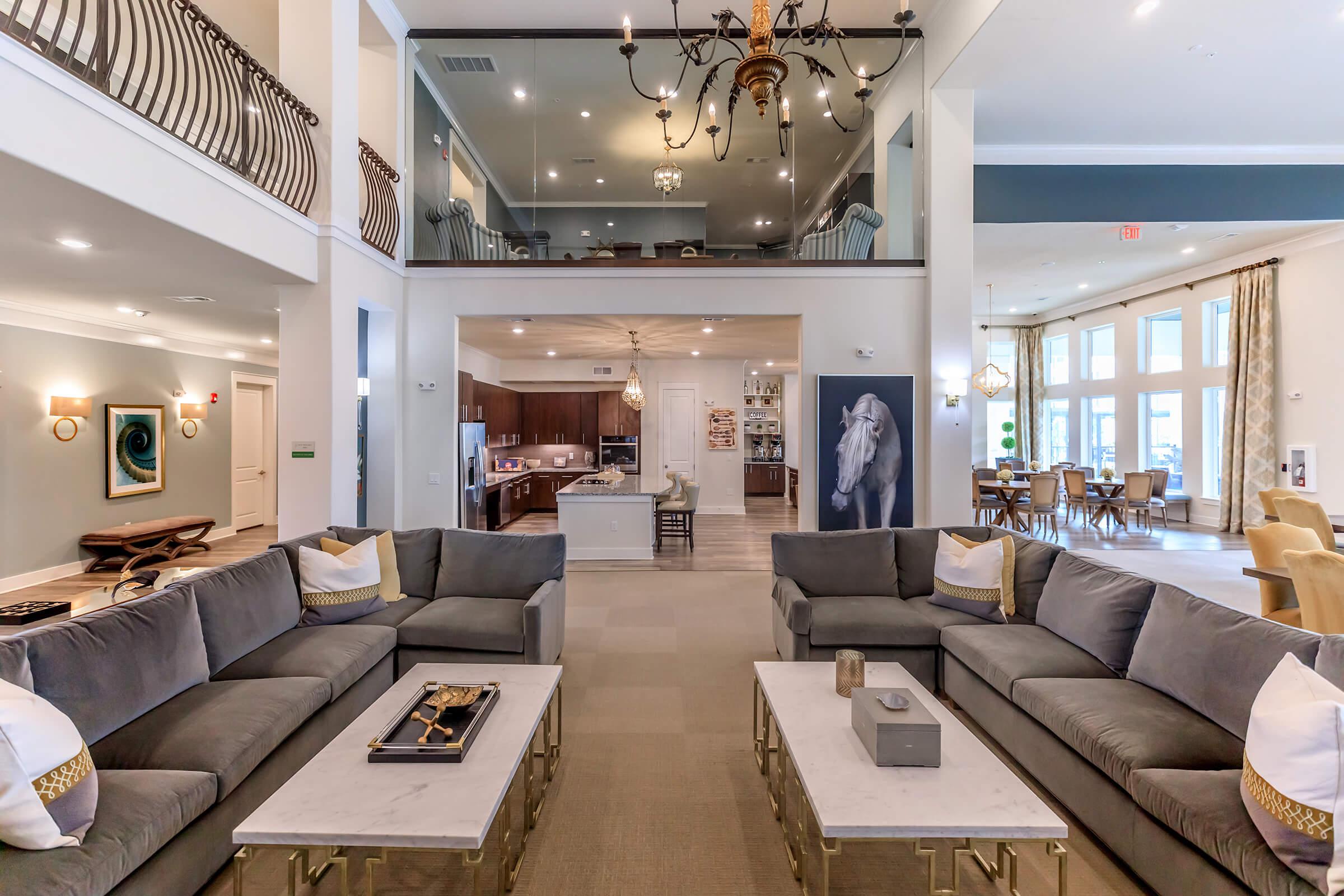 a living room filled with furniture and a large window