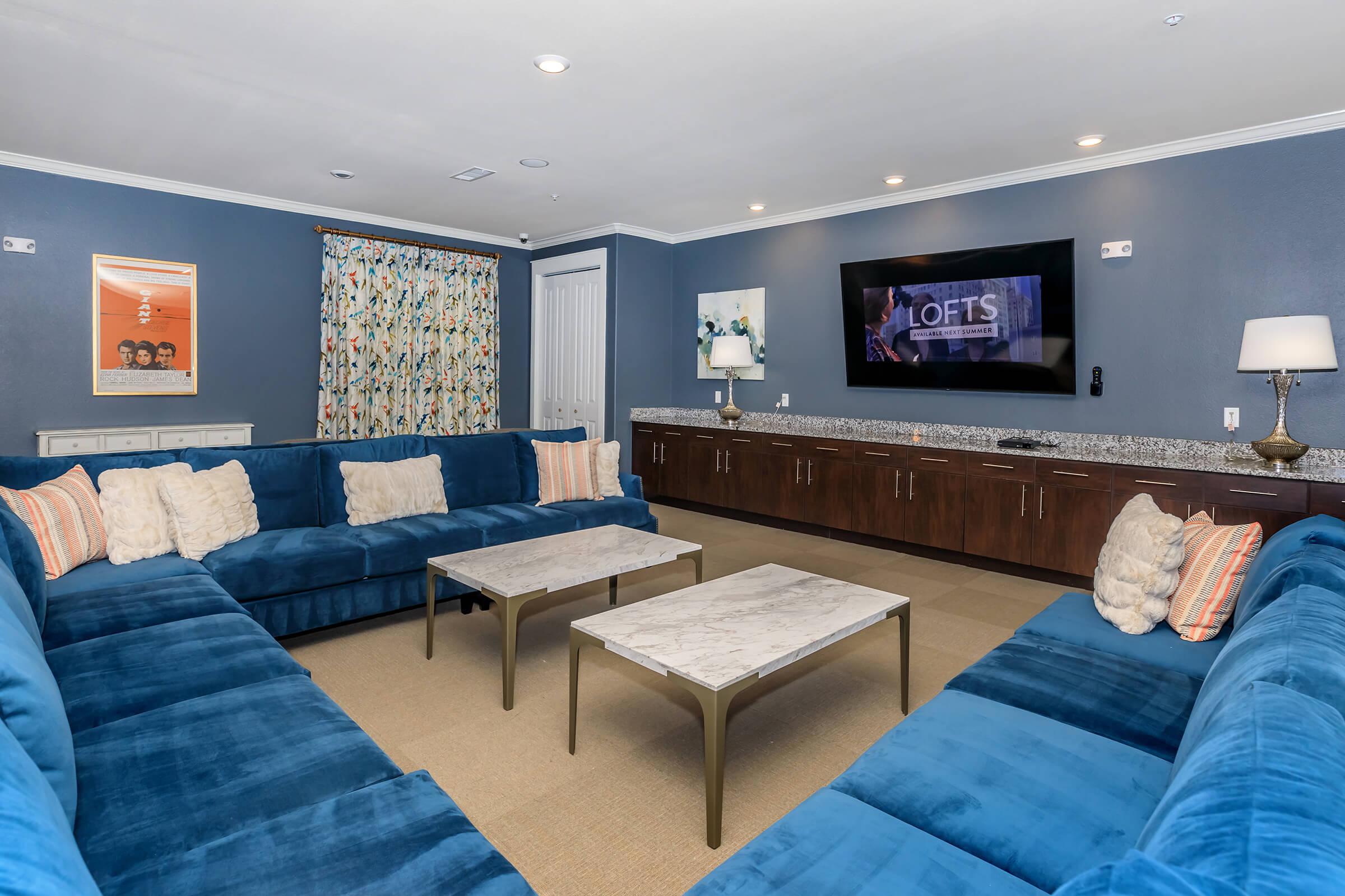 a living room filled with furniture and a flat screen tv