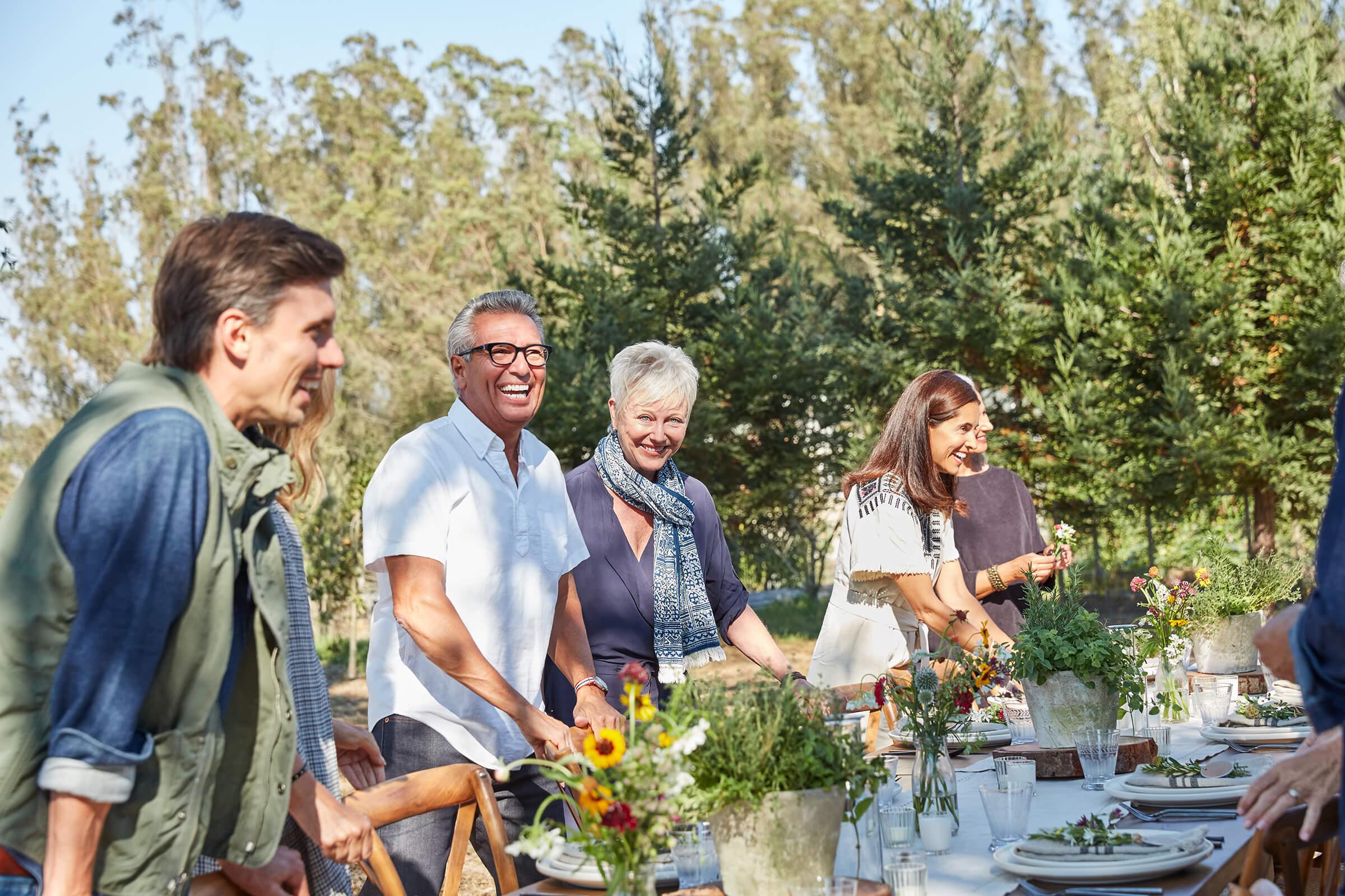 a group of people standing around a table