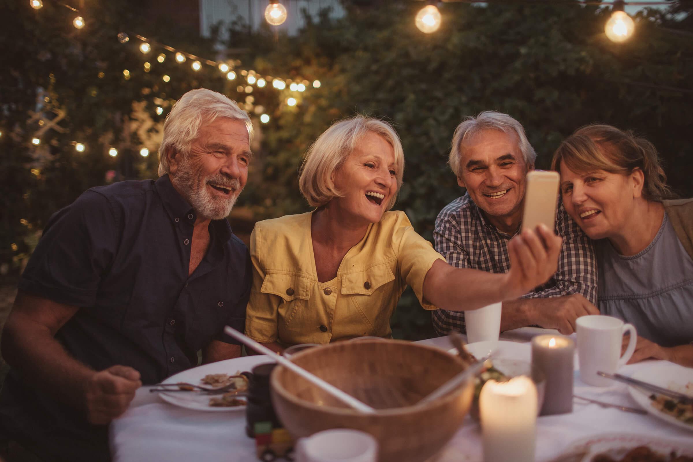 a group of people sitting at a table with food