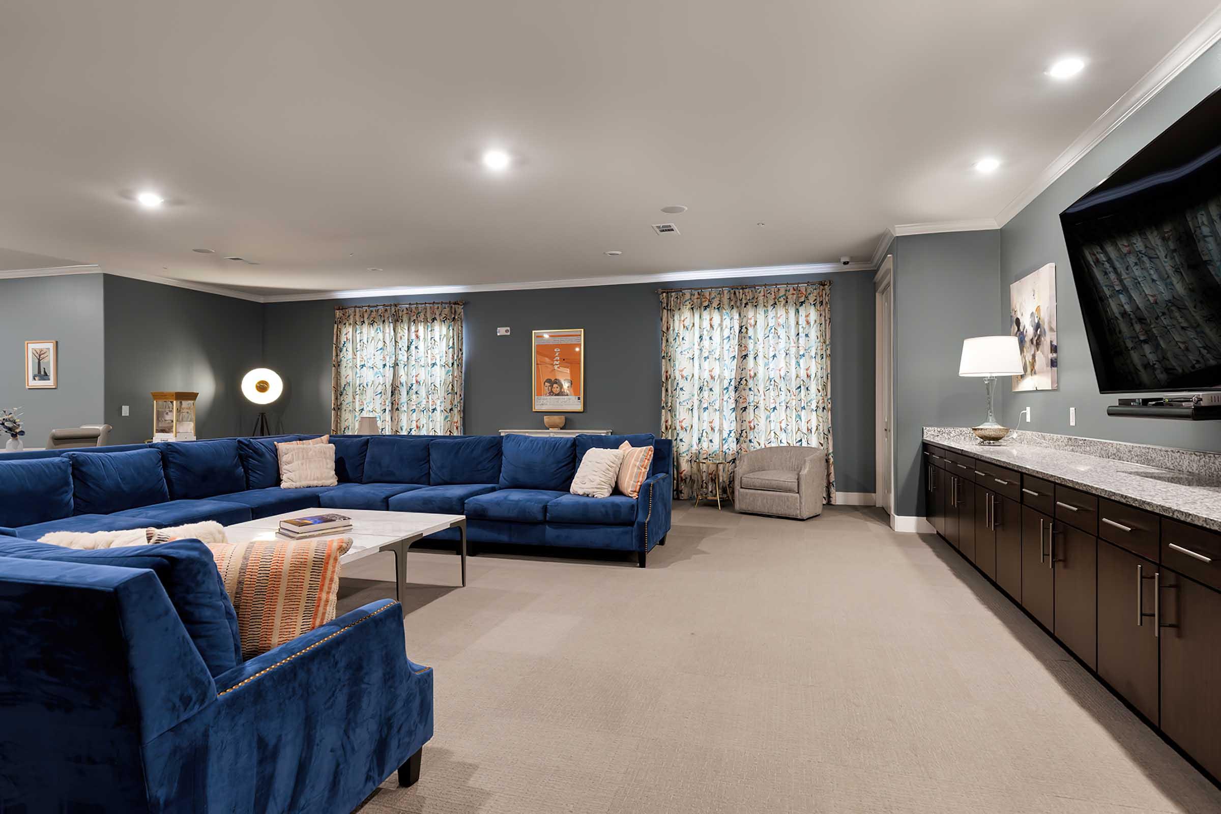 a living room filled with furniture and a large window