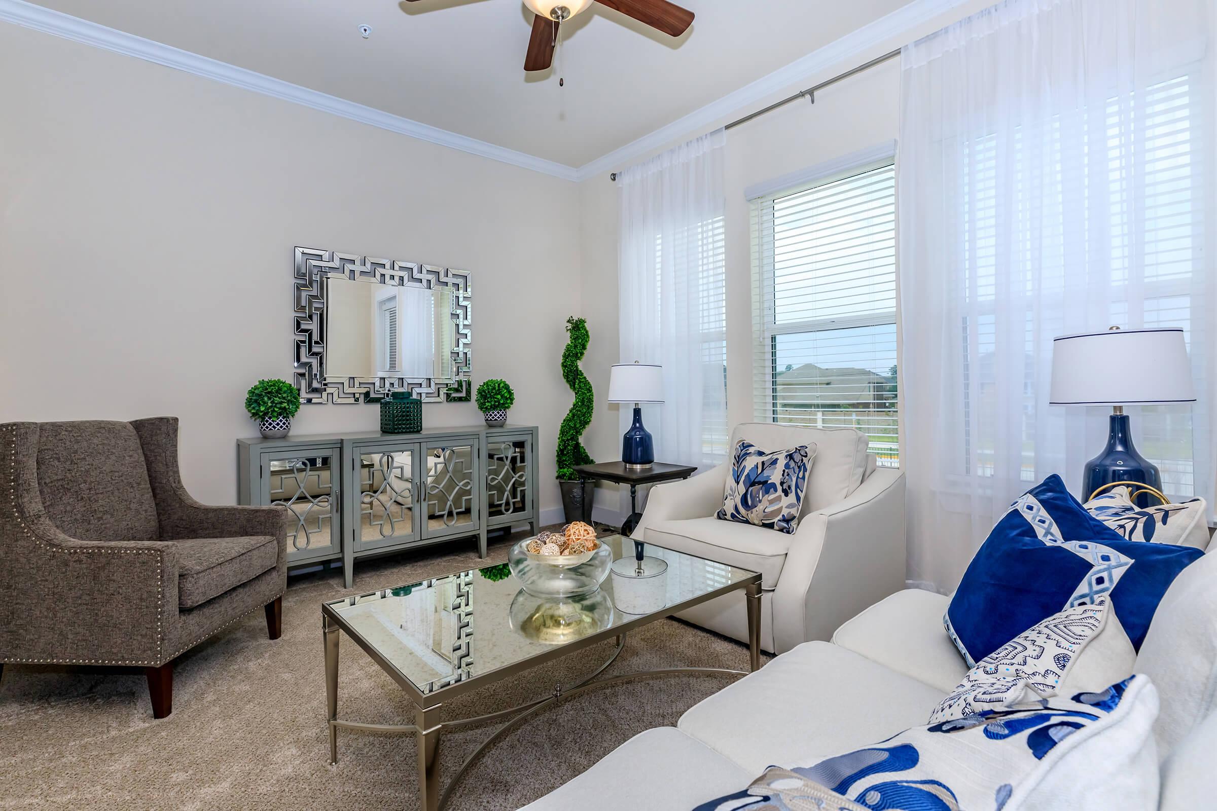 a living room filled with furniture and a large window