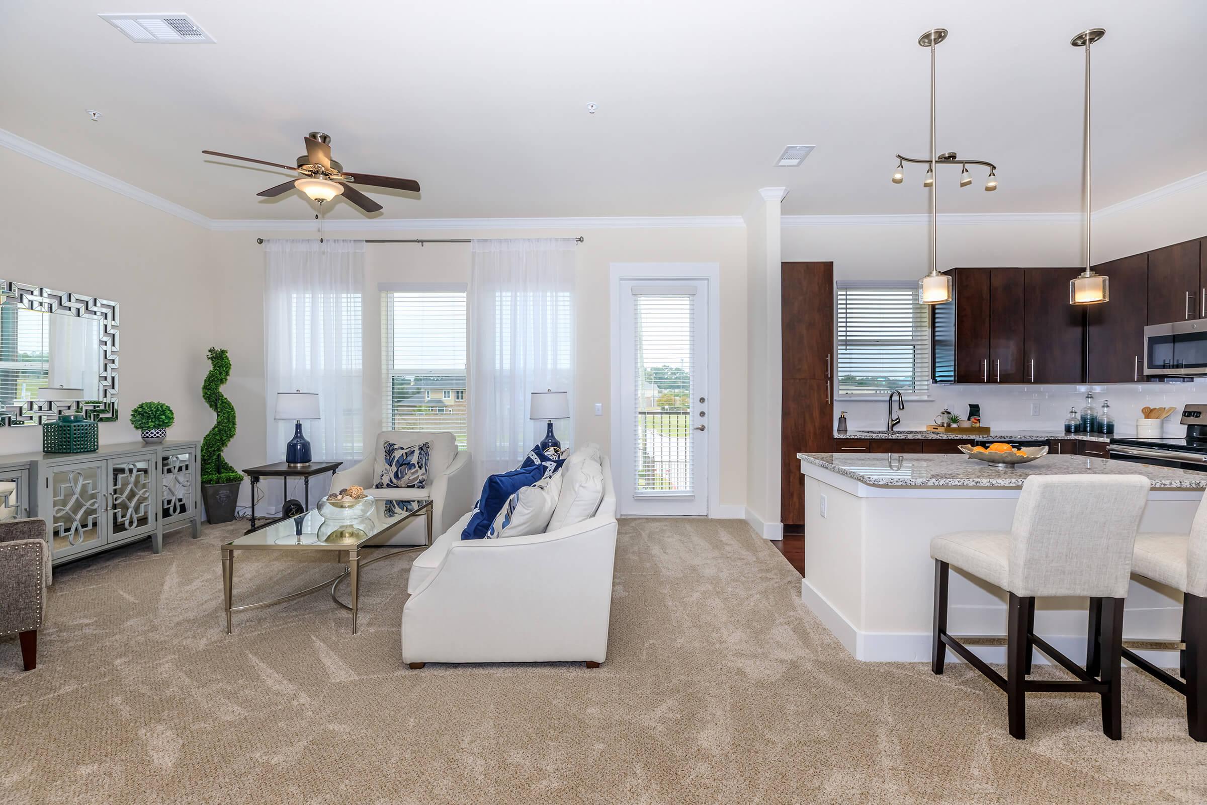 a living room filled with furniture and a large window