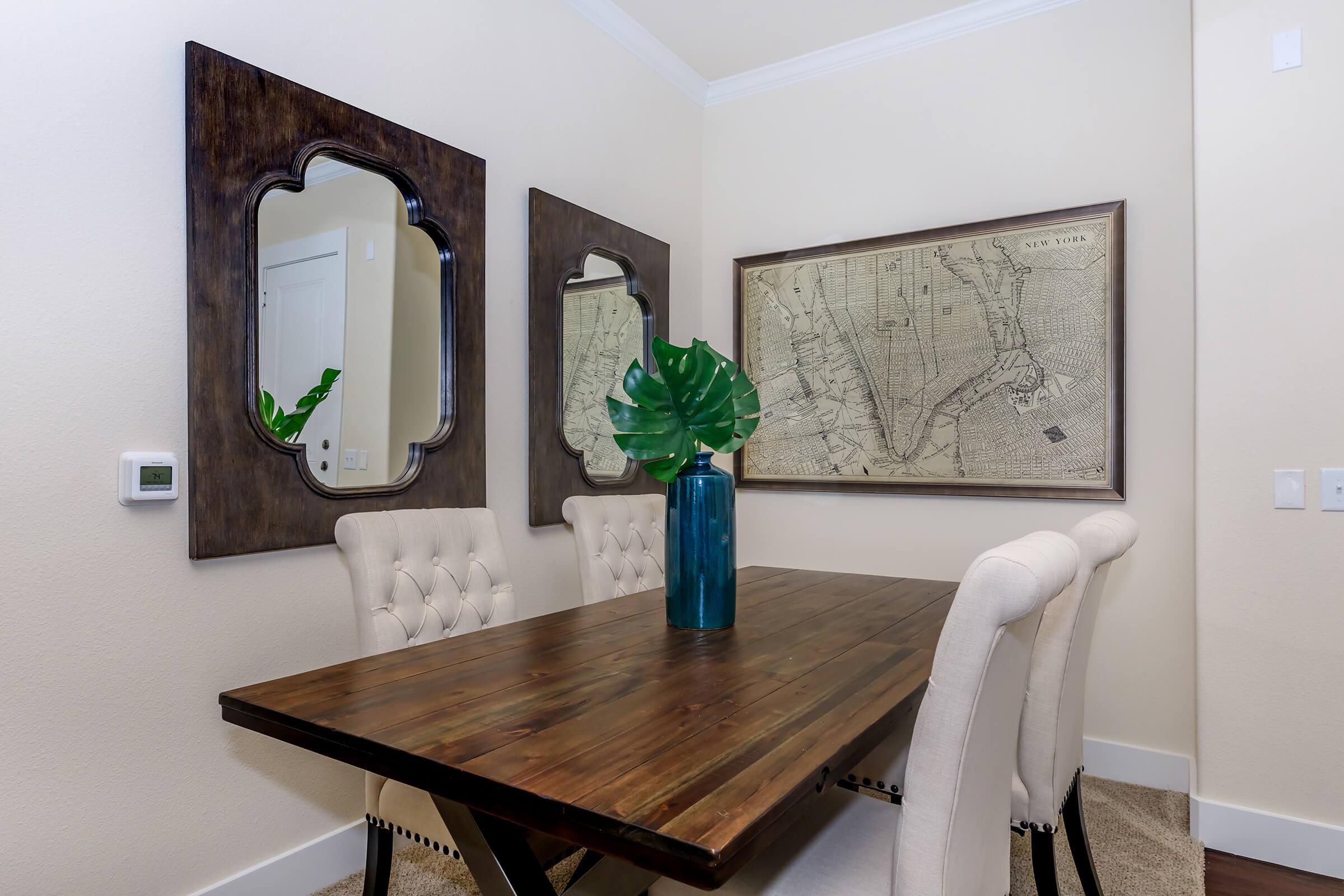 a room with a couch and a table in front of a mirror