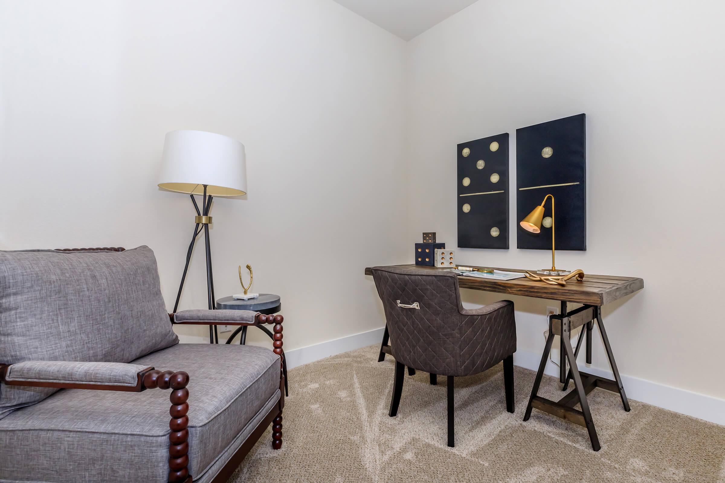 a living room filled with furniture and a lamp