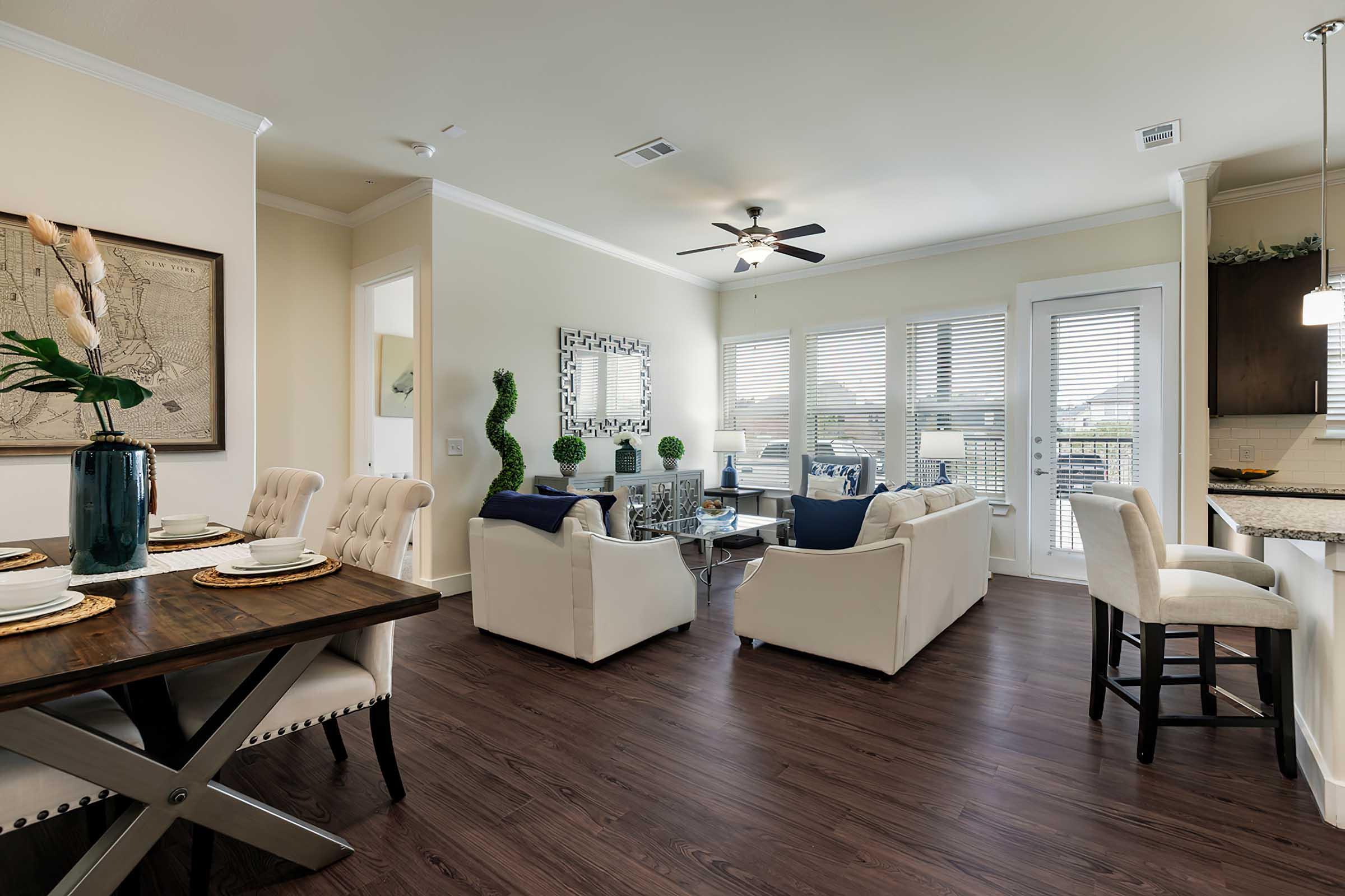 a living room filled with furniture and a large window