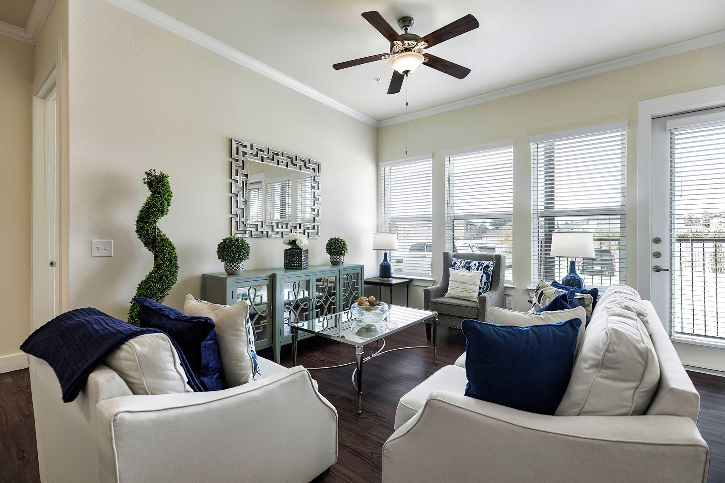 a living room filled with furniture and a large window