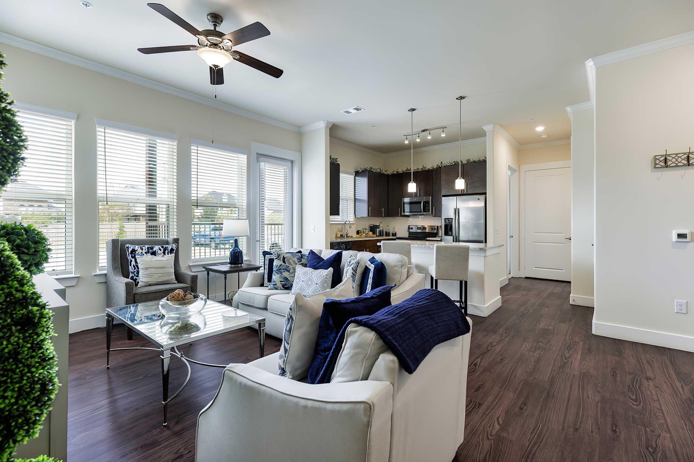 a living room filled with furniture and a large window