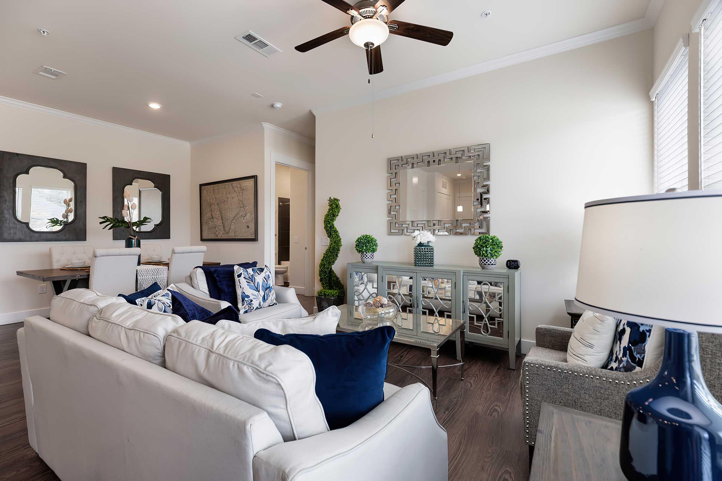 a living room filled with furniture and a large window