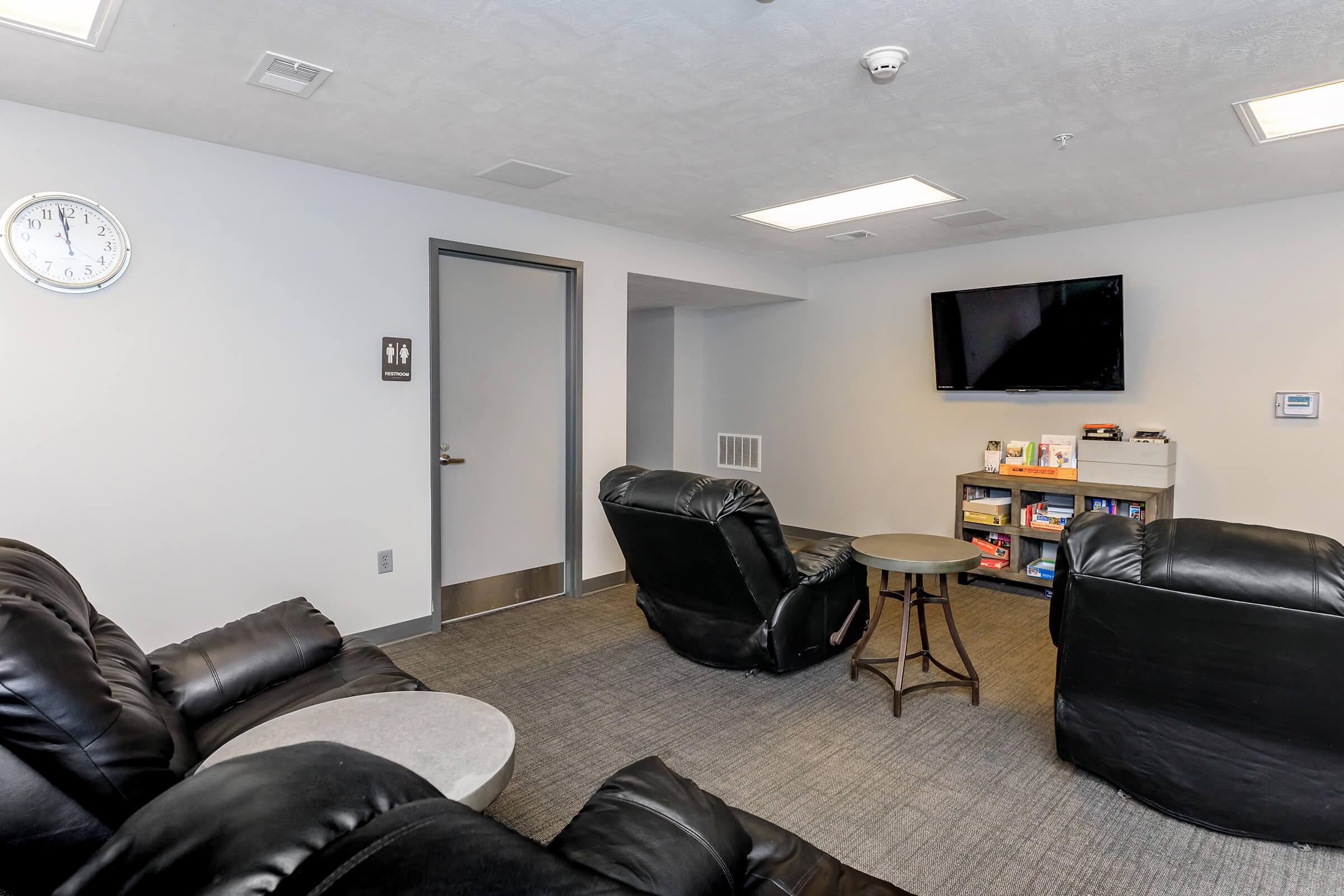 a living room filled with furniture and a flat screen tv