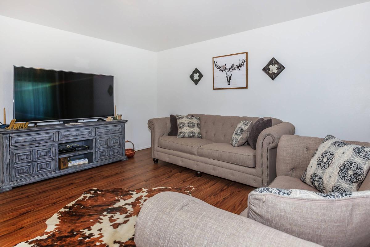 a living room filled with furniture and a flat screen tv