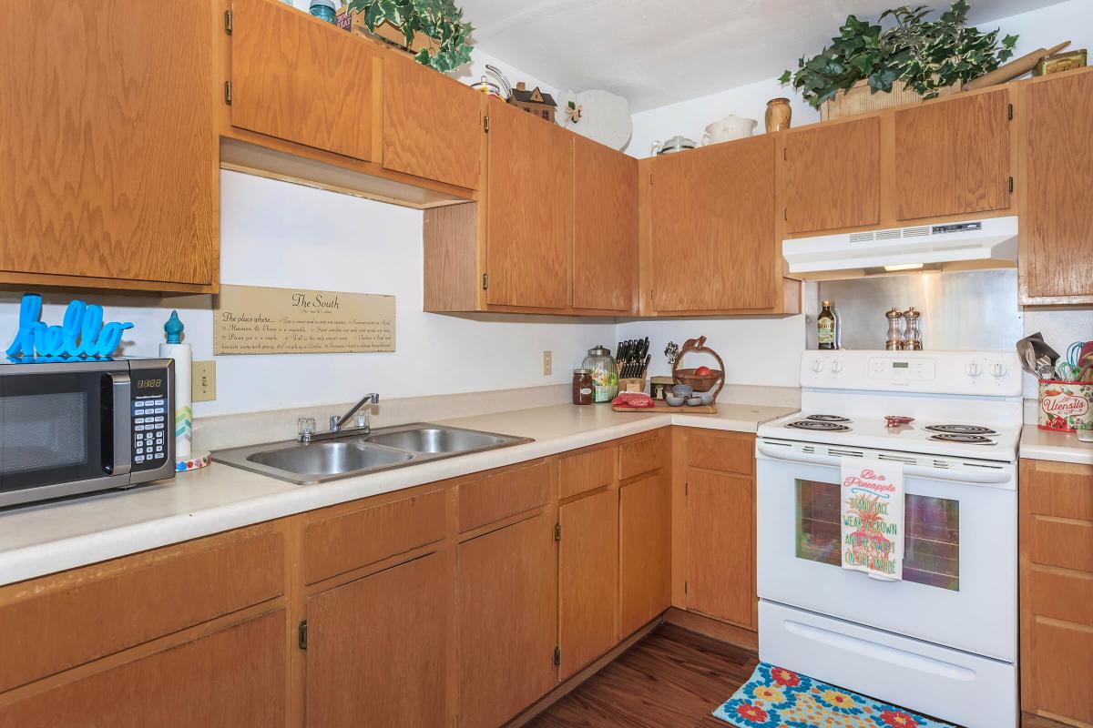 a kitchen with stainless steel appliances and wooden cabinets