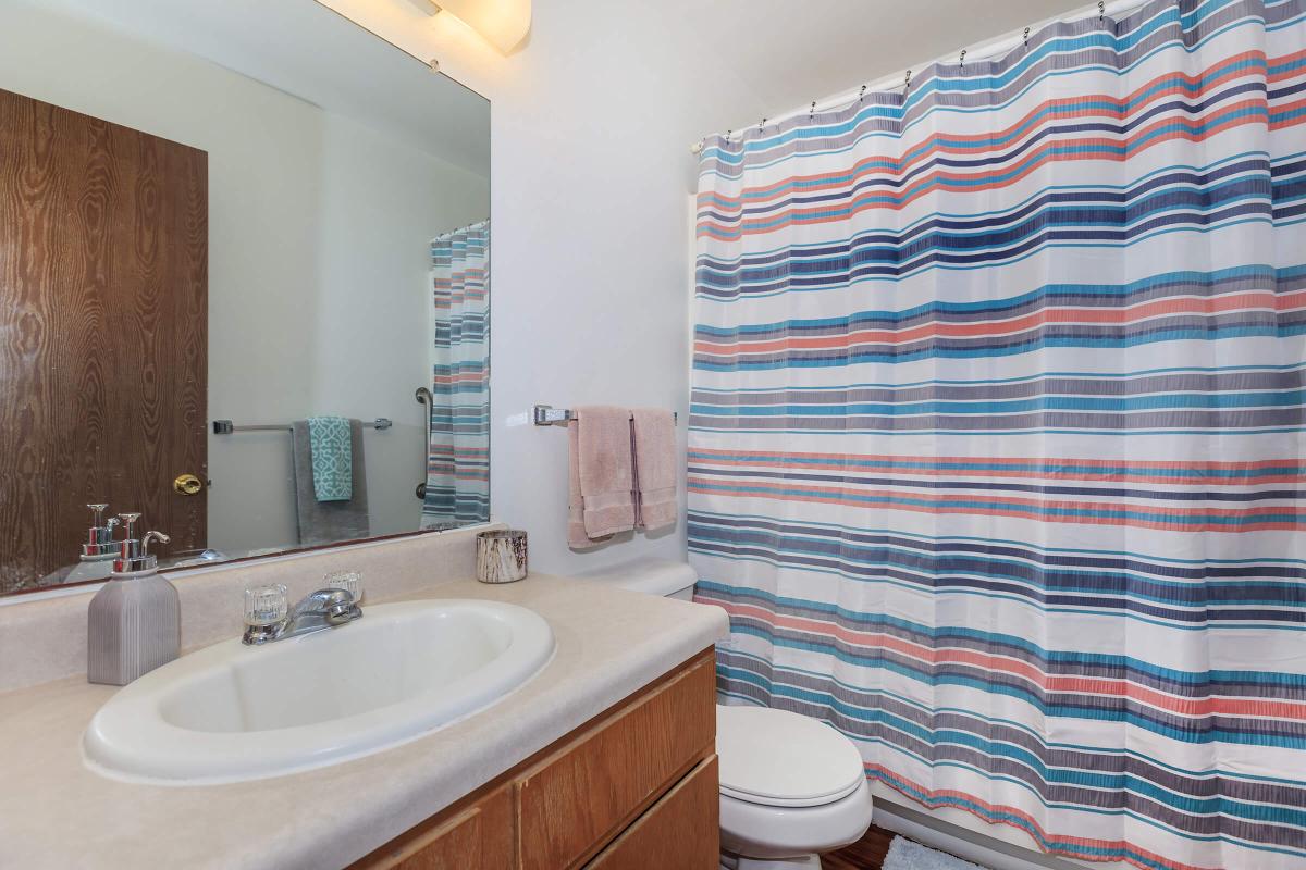 a large white tub sitting next to a sink