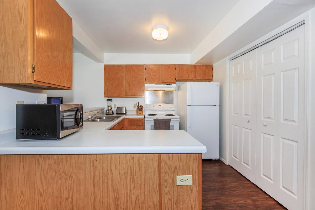 a kitchen with stainless steel appliances and wooden cabinets