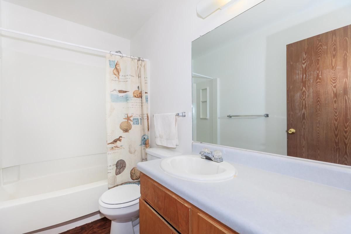 a large white tub sitting next to a sink