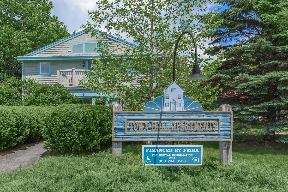 a sign in front of a house