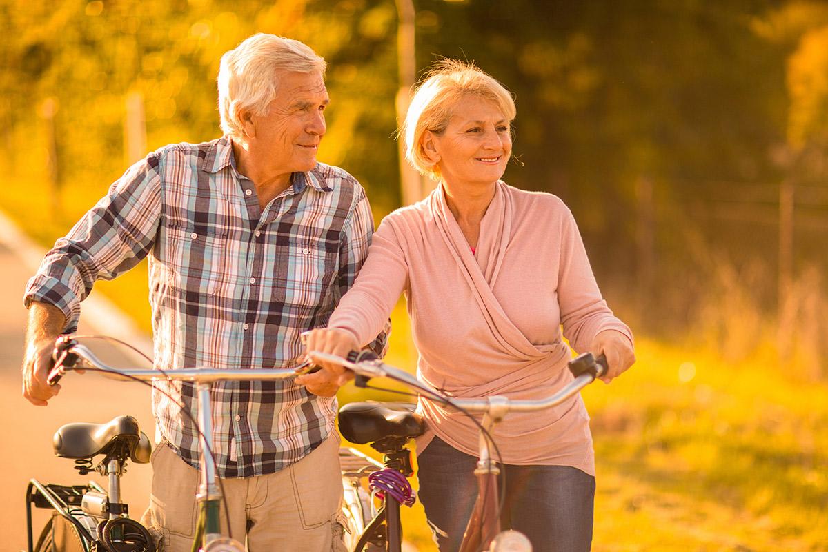 a man and a woman riding on the back of a motorcycle