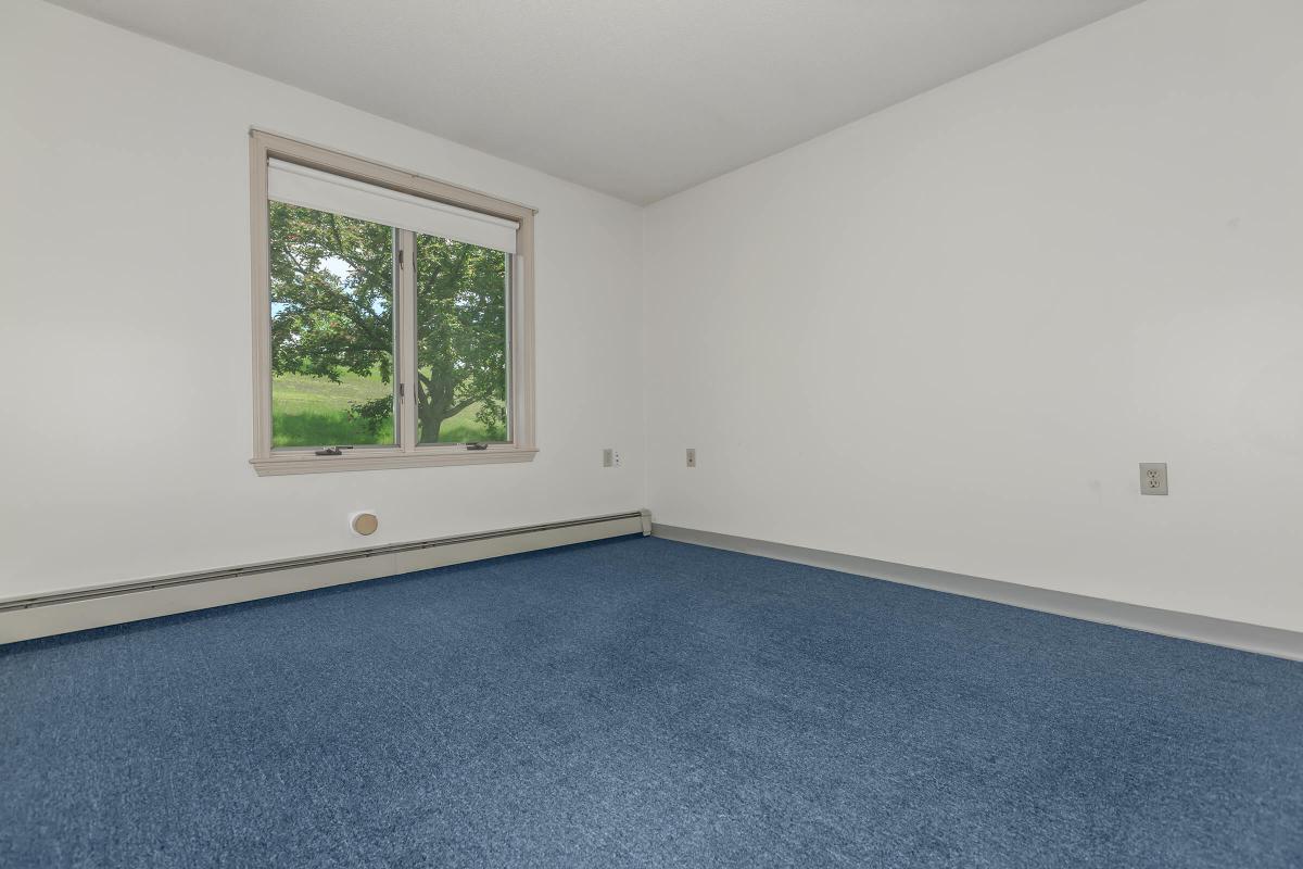 a bedroom with a large window