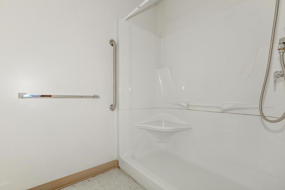 a white tub sitting next to a shower