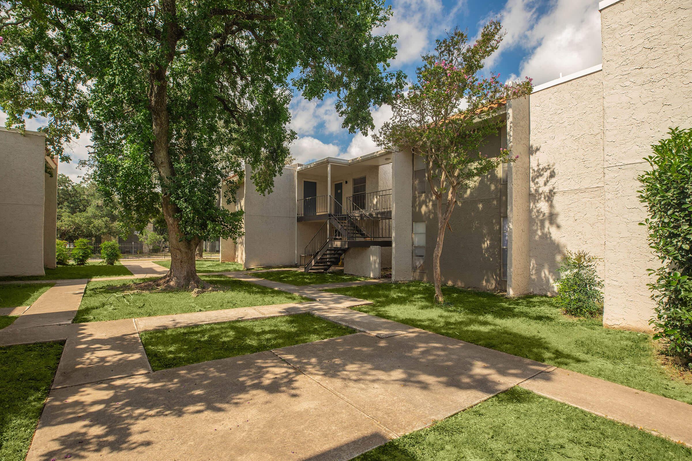 a stone path in front of a brick building