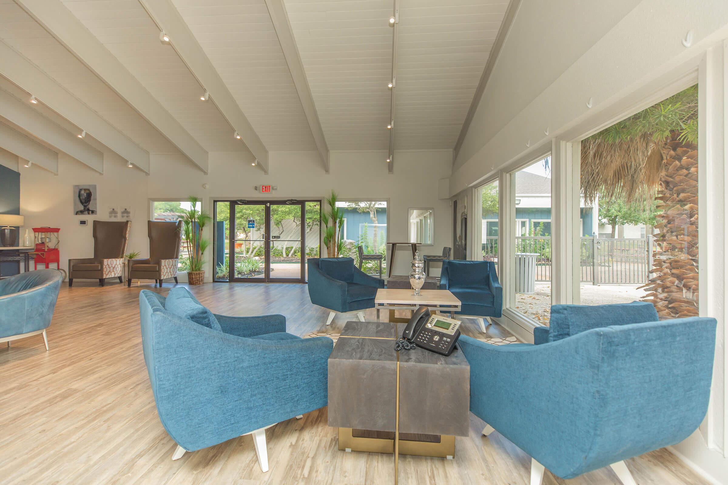 a living room filled with furniture and a large window