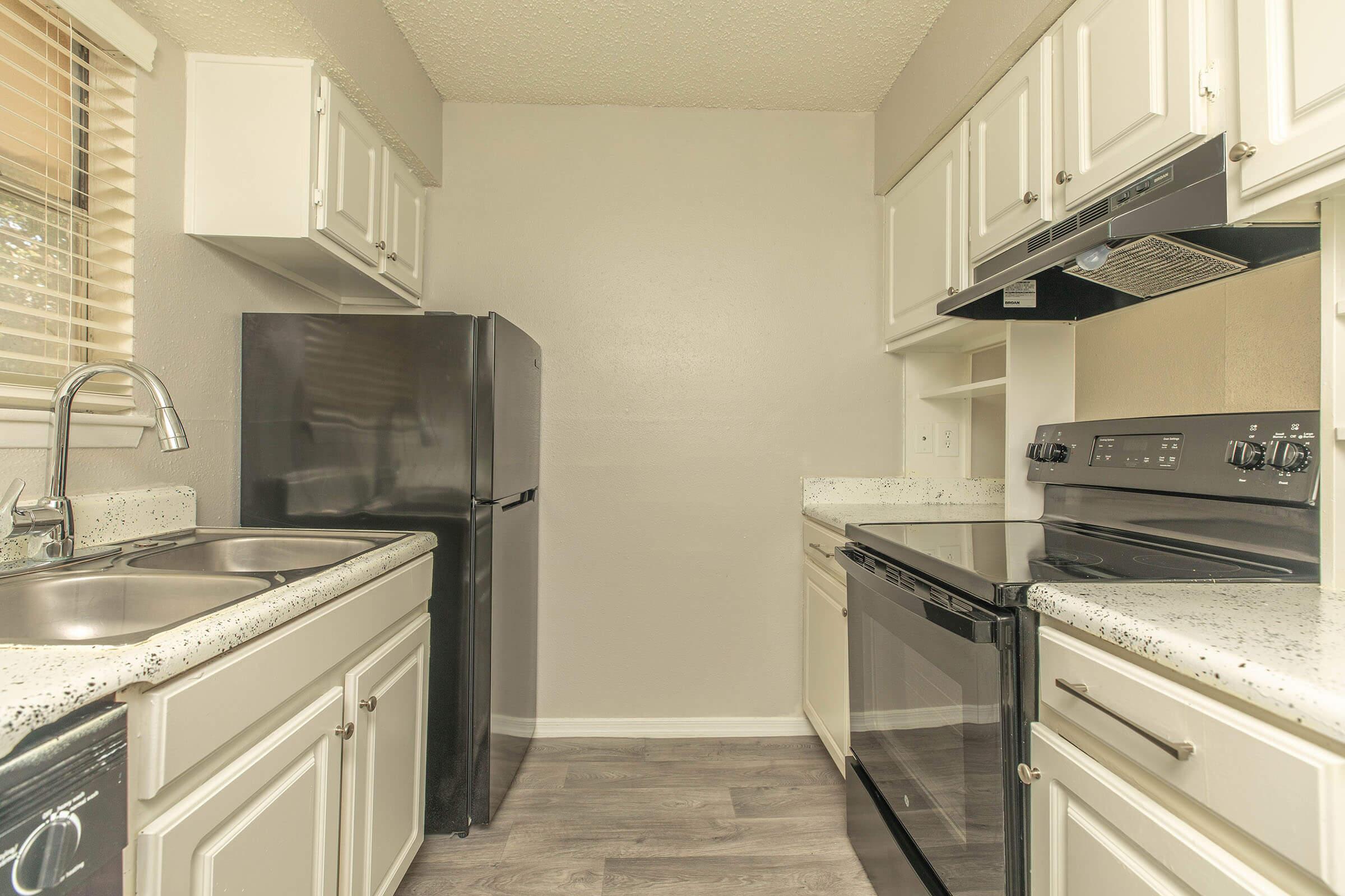 a stove top oven sitting inside of a kitchen