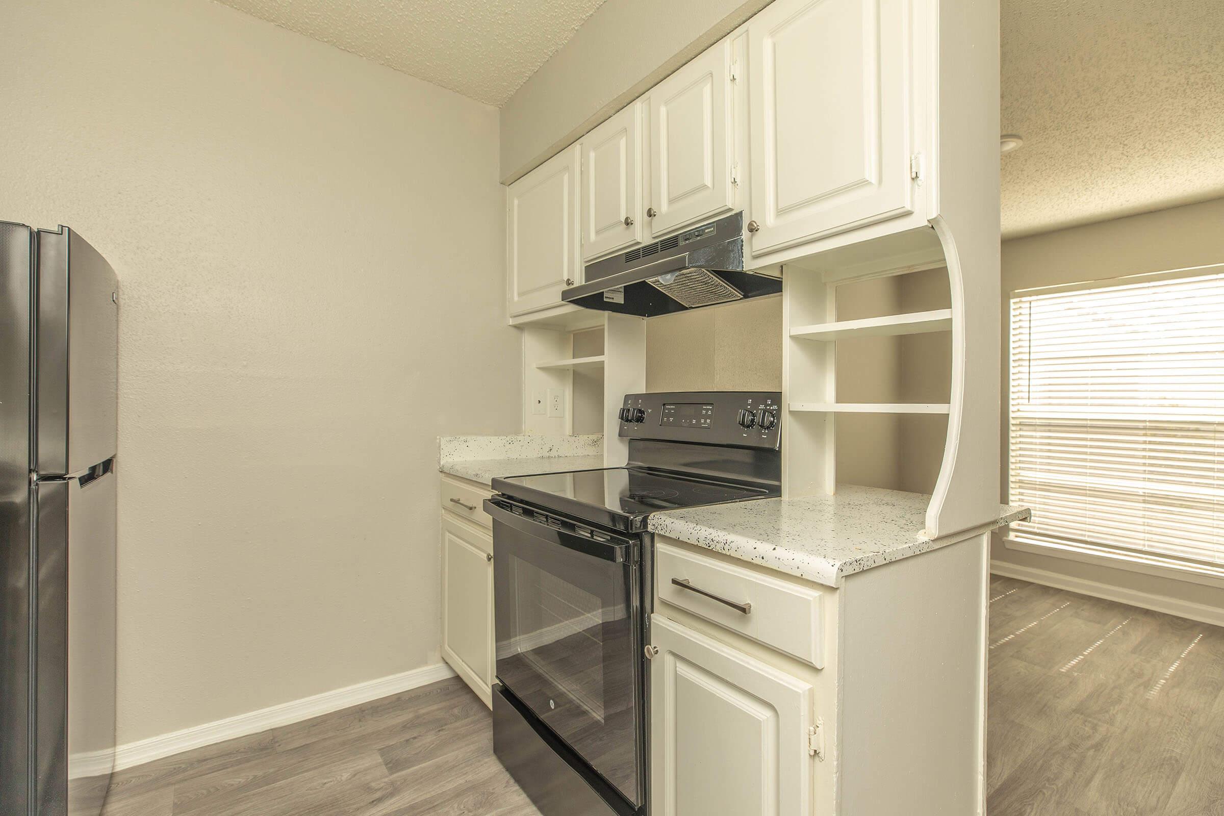 a kitchen with a stove and a refrigerator