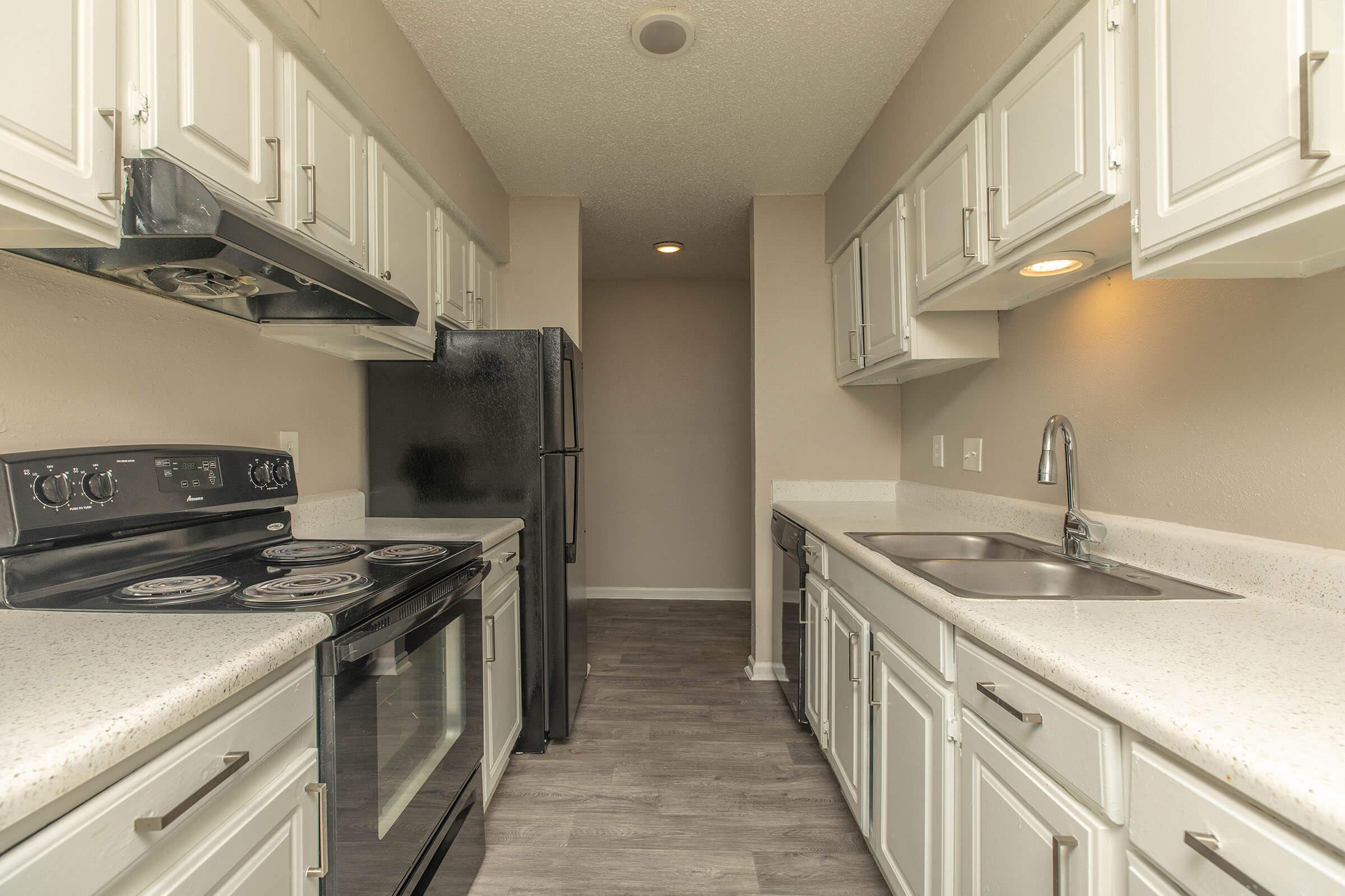 a stove top oven sitting inside of a kitchen