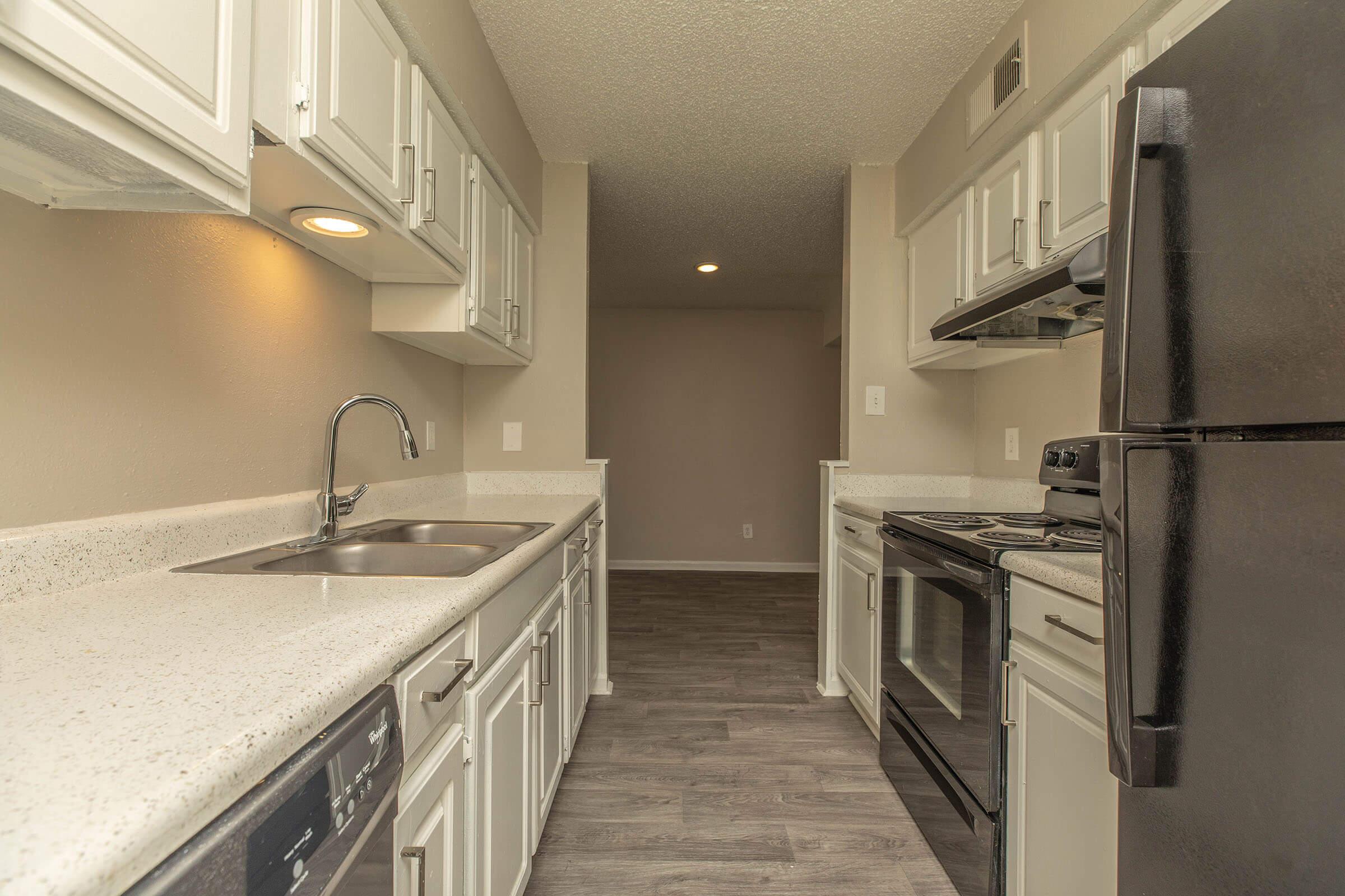 a kitchen with a stove and a sink