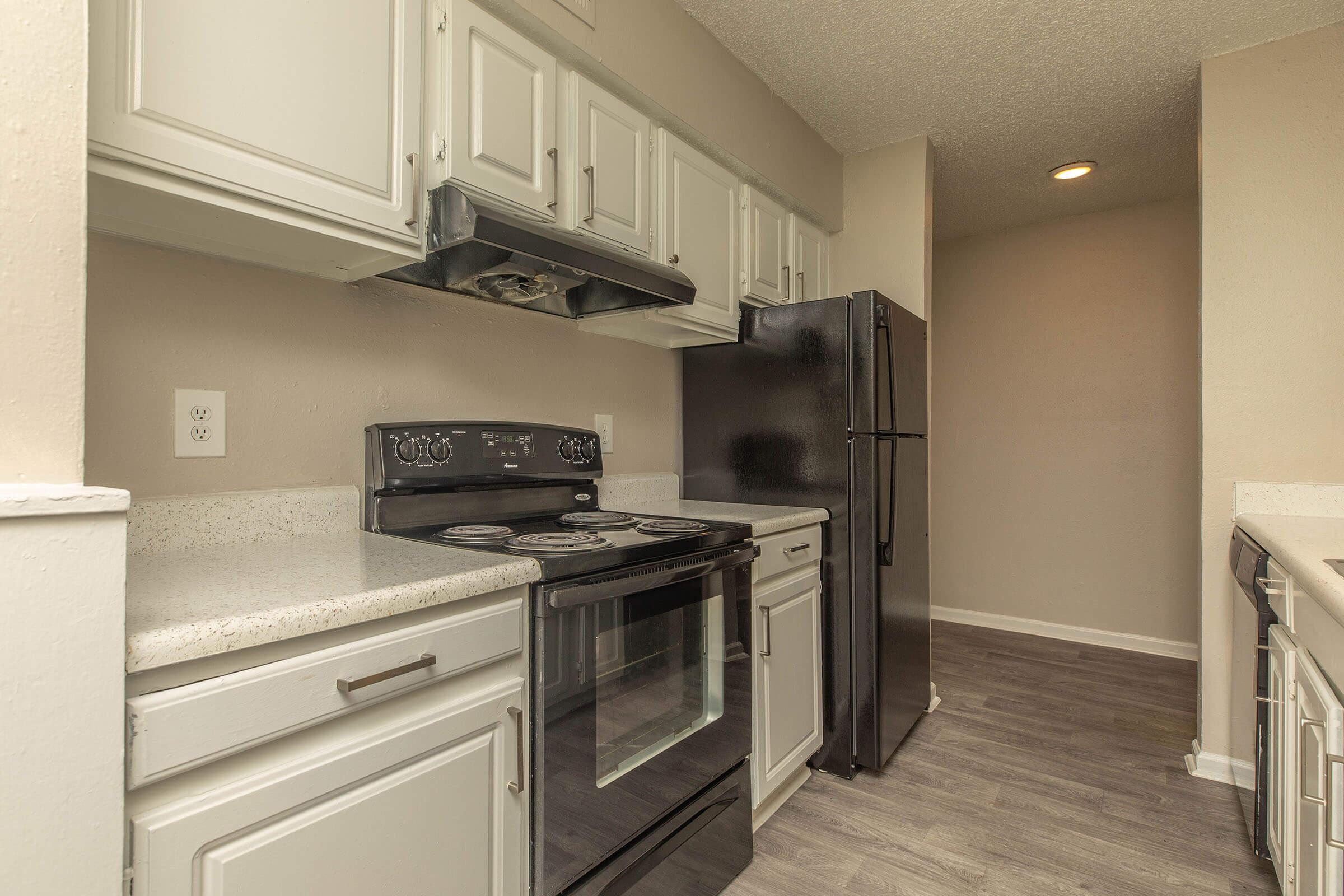 a kitchen with a stove and a refrigerator